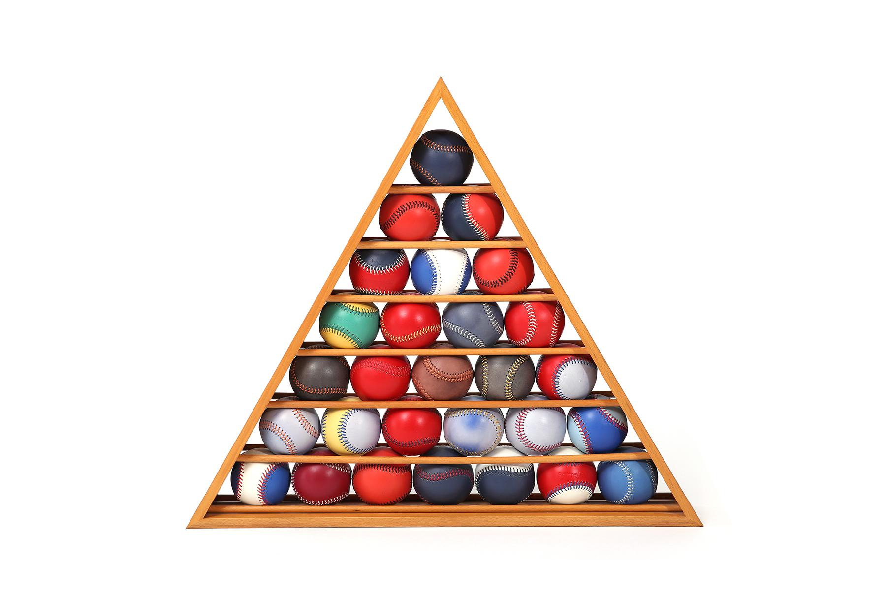 These colorful baseballs have been fabricated in fine Spinneybeck leather and placed on shelves inside a triangular shaped sculptural frame. These baseball sculptures were given to Knoll VP's and executives and are rarely seen. The perfect rare gift