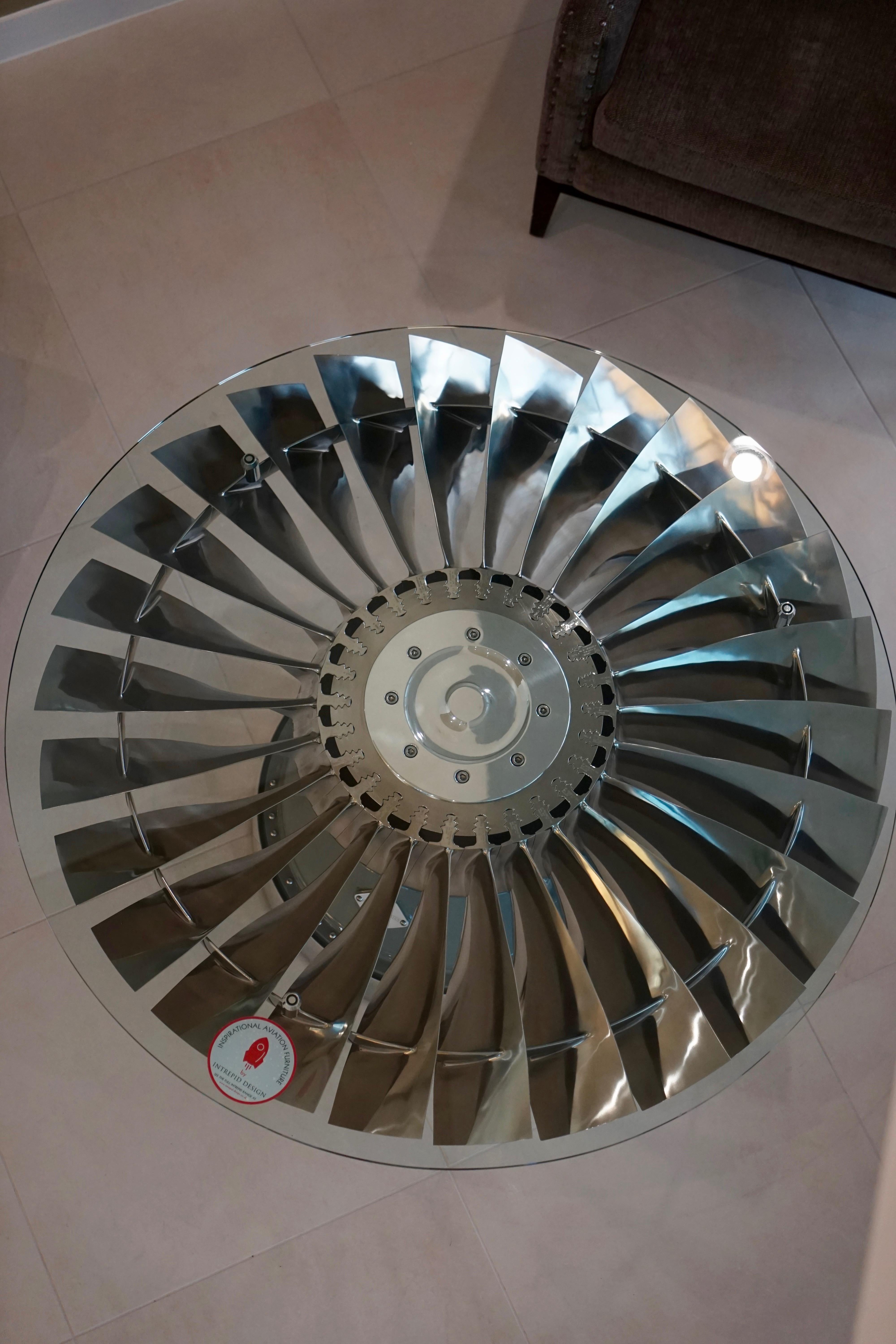 Harrier Jump Jet Pegasus LP1 Fan Blade, positioned on its original hub from within the jet engine. 

Simply stunning coffee table with 26 individual polished titanium blades, positioned on top of an original painted harrier hub. Available with the