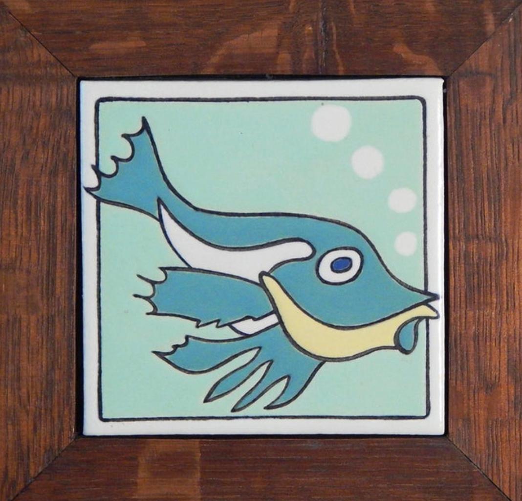 Cleanly designed and beautifully glazed by the Mosaic Tile Company of Zanesville, Ohio in the 1930s, this Classic Art Deco tile is framed in its original quartersawn oak frame. Founded in the 1890s, the Mosaic company reached its peak in the 1920s