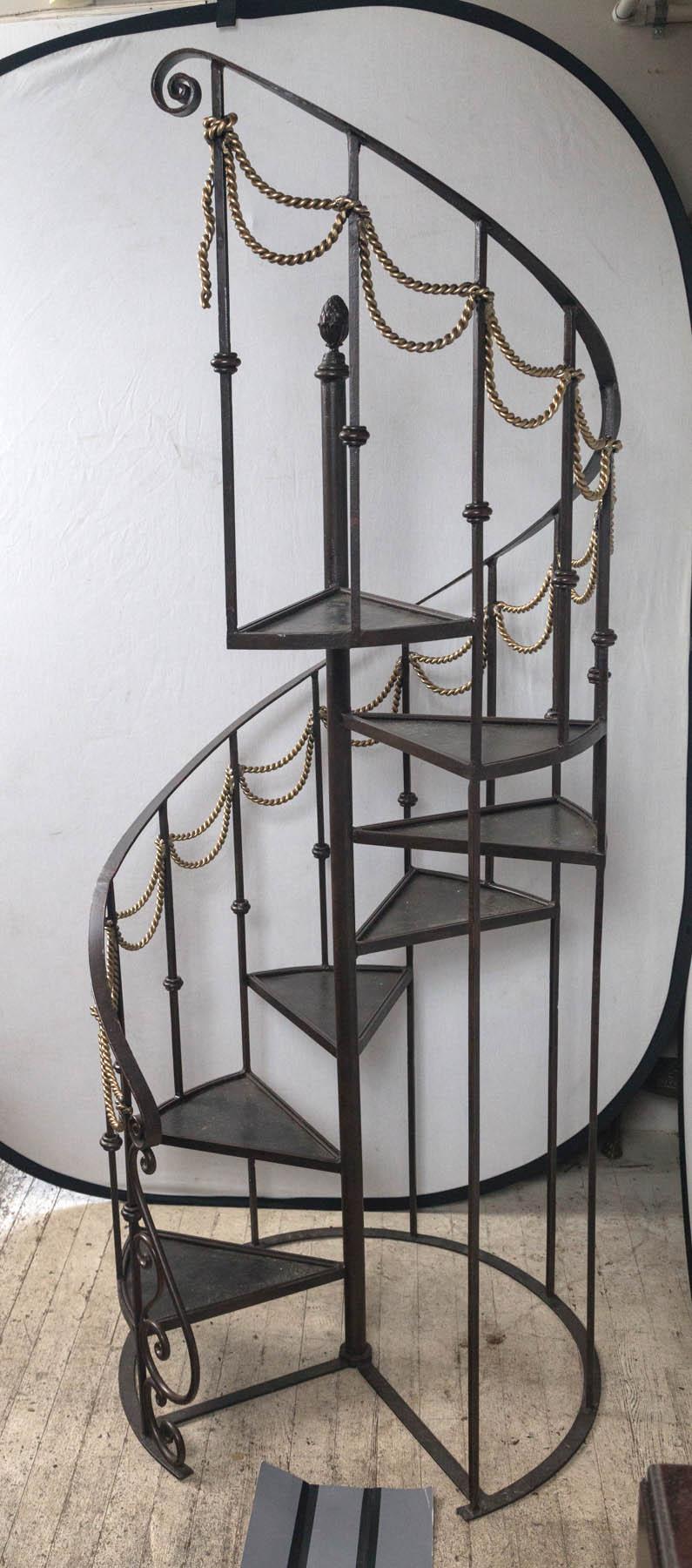 Black iron with double rows of brass swags between the verticals. Seven steps. Top step is set at 49 inches. We have personally climbed to the stop step several times and found them to be quite sturdy. Great also for displays.