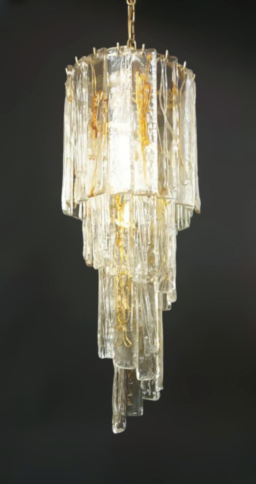 Vintage Italian spiral chandelier with clear and amber Murano glass planks / Made in Italy by La Murrina, circa 1960s
Original mark on glass
Measures: diameter 12 inches, height 31.5 inches plus chain and canopy
5 lights / E12 or E14 type / max 40W