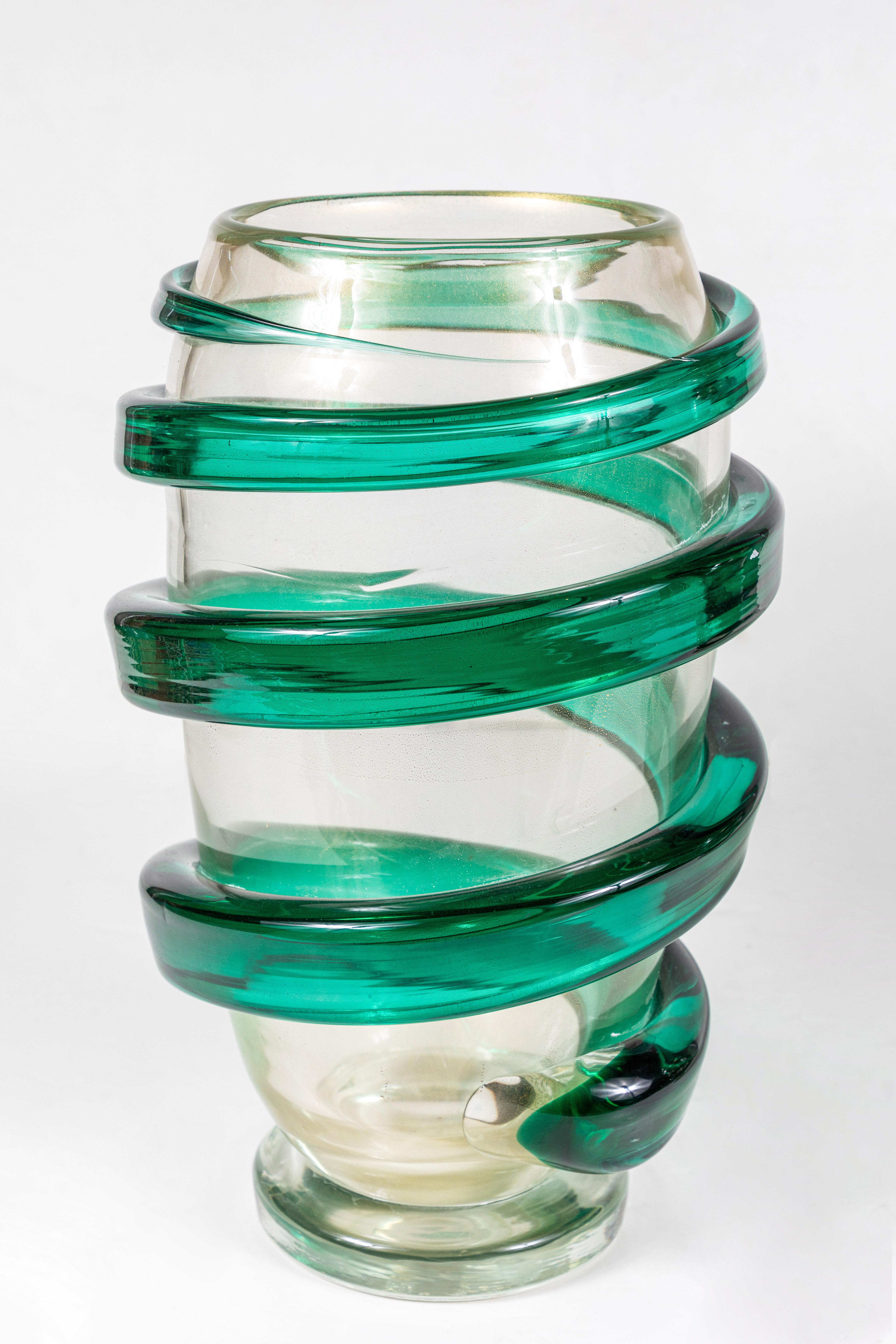 Fabulous pair of 1960s, hand blown, Murano vases embellished with 22-karat gold flecks and surrounded by vibrant, spiral, green extrusions. The vases are signed, though the signature is illegible. Signed 