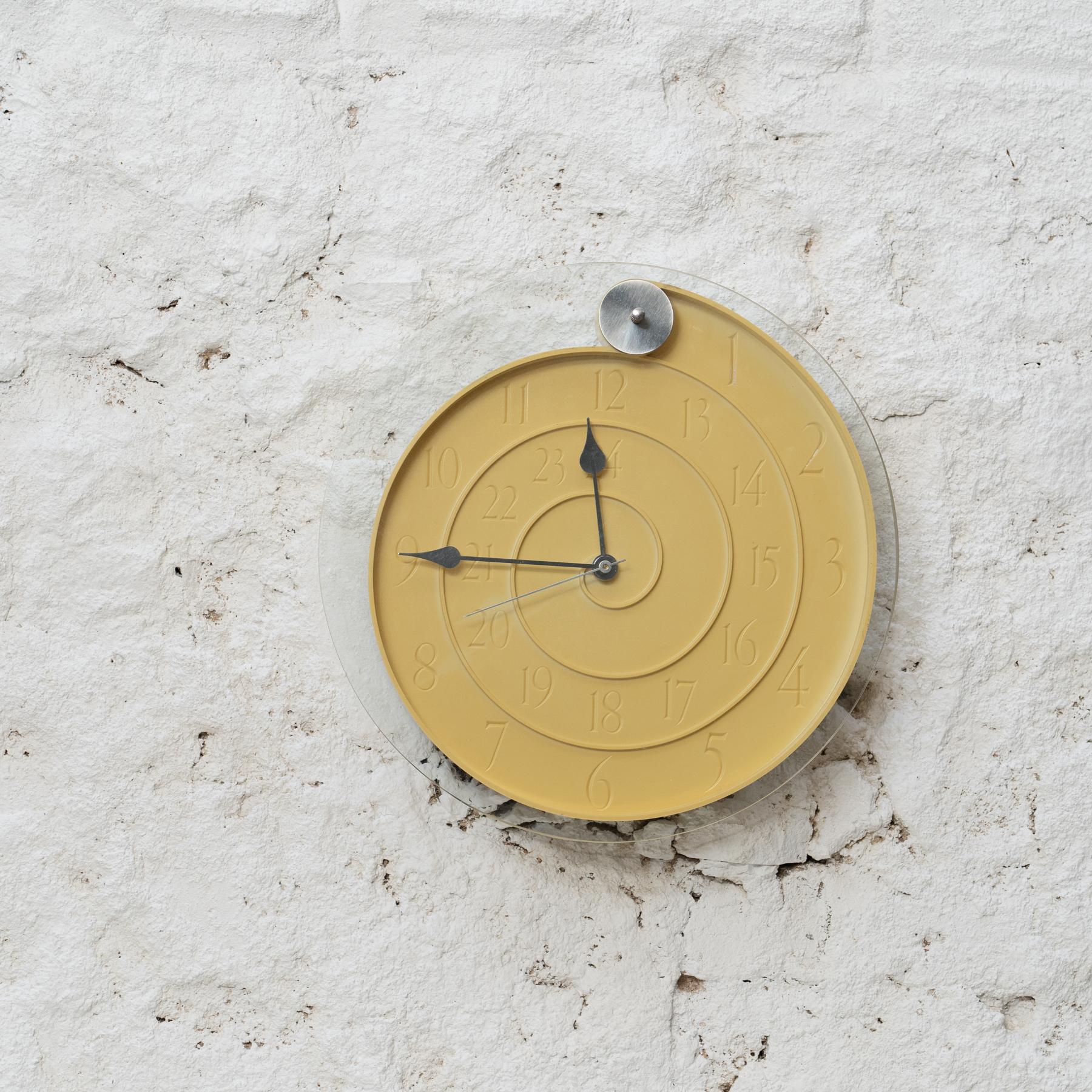     Designer: Oscar Tusquets
    Manufacturer: Mobles 114, Spain
    Year: circa 1996
    Materials: Yellow Mustard Plastic and Glass

Original Condition  Minimalist Charm  Spiraled Sophistication

Step into the world of unconventional timekeeping