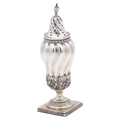 Spiral silver candlestick with reliefs, friezes and square base