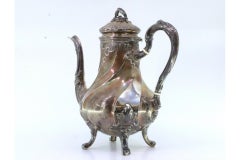 Spiral silver kettle with reliefs, applications and four claw feet