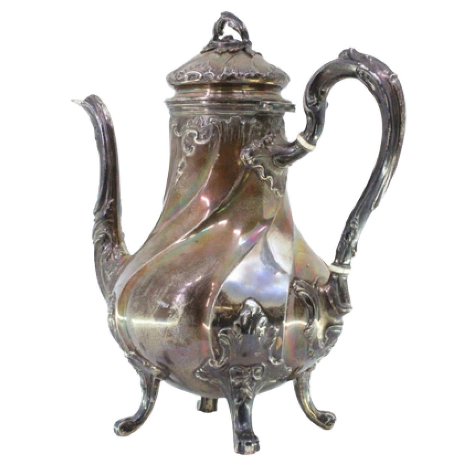 Spiral silver kettle with reliefs, applications and four claw feet