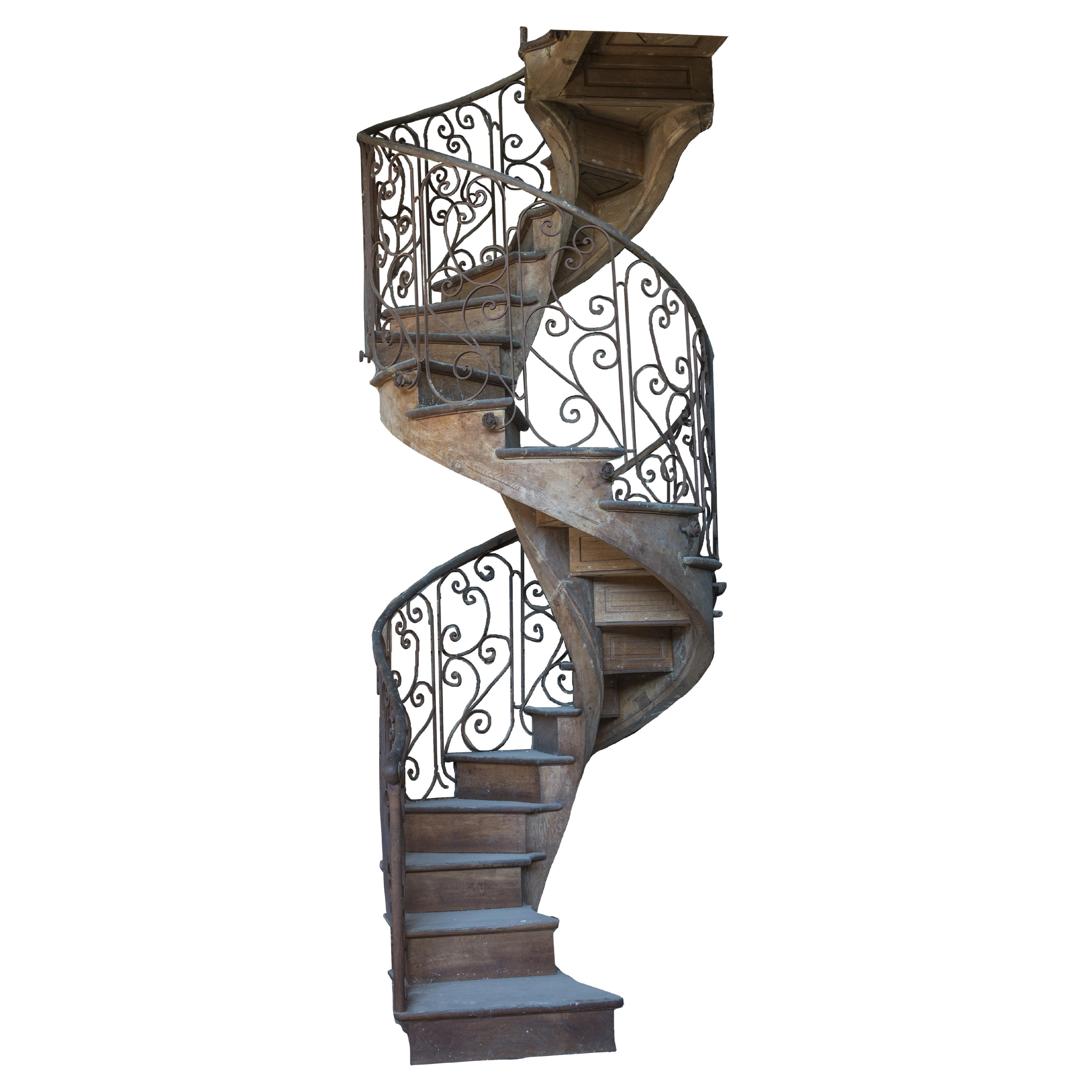 Spiral staircase with a wrought iron railing