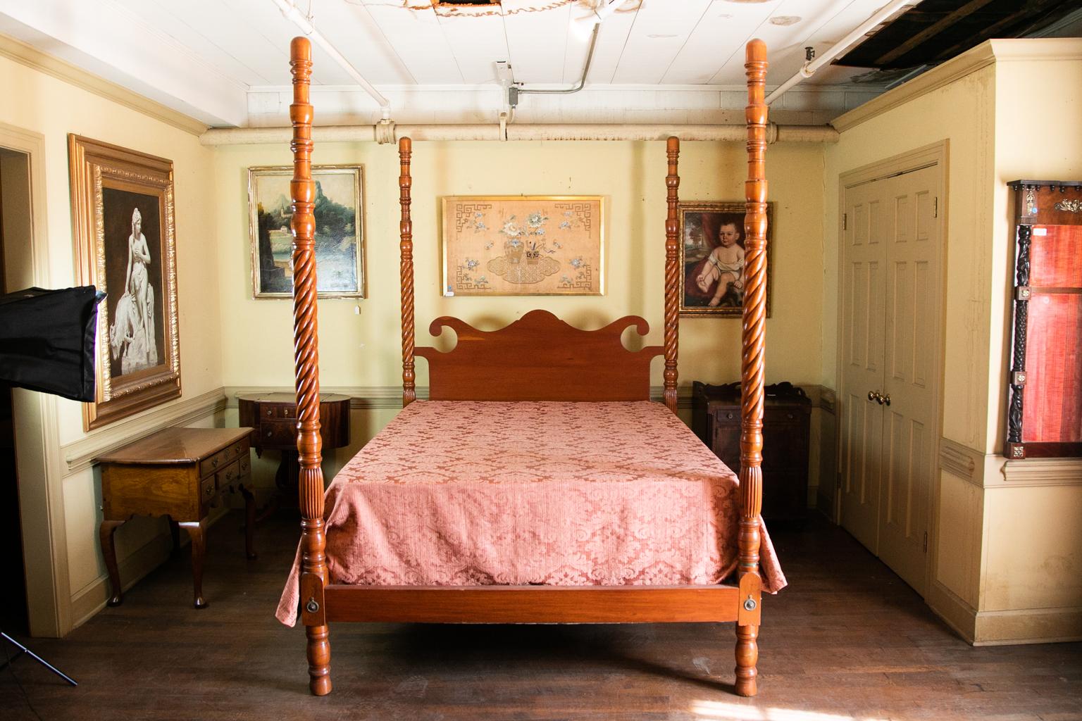 Spiral turned queen size poster bed is fruitwood with a scrolled headboard. The four posts have reeded knops and terminate in turned feet. The four posts date to circa 1840, the rails and headboard have been custom made to accommodate a contemporary