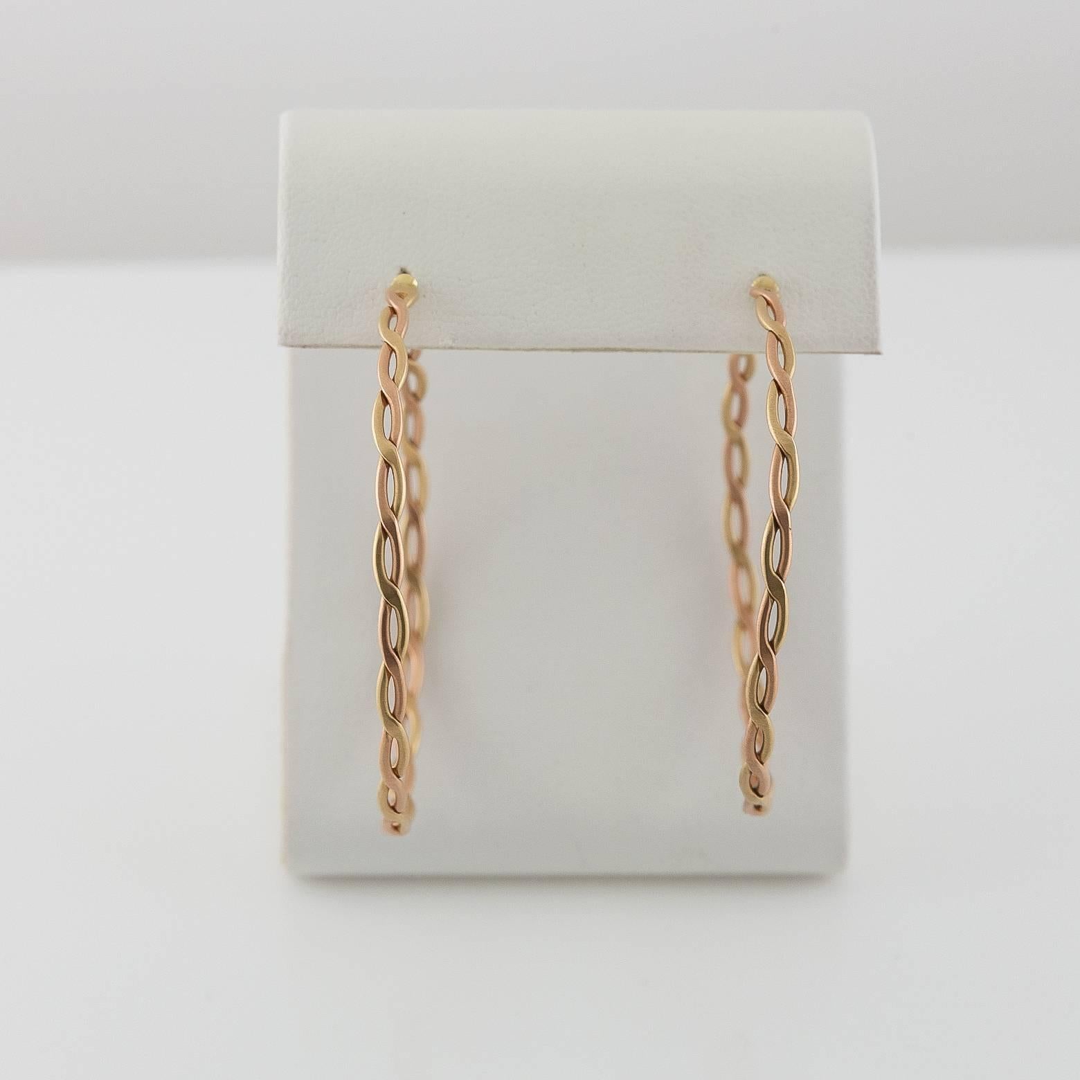 These beautiful woven medium-large sized hoop earrings blend together rose gold twisted with yellow gold accents The hoops are flexible and lightweight and have a matte finish. Very wearable, comfortable and add a little extra intricate detail to