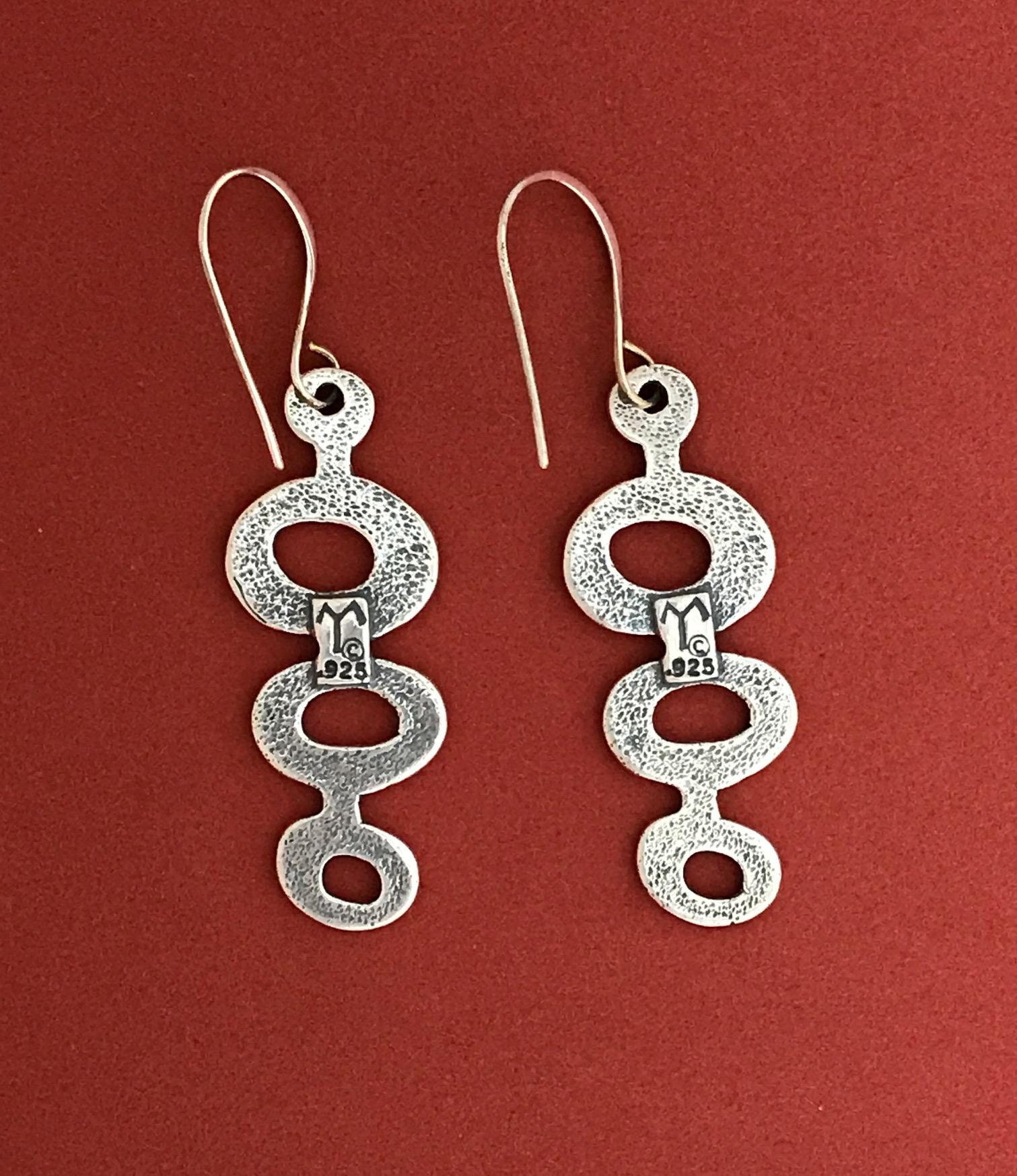 Spirit Ponds, Melanie Yazzie cast sterling silver dangle earrings Native America

Sterling Silver casting  Melanie A. Yazzie (Navajo-Diné) is a highly regarded multimedia artist known for her printmaking, paintings, sculpture, and jewelry designs.