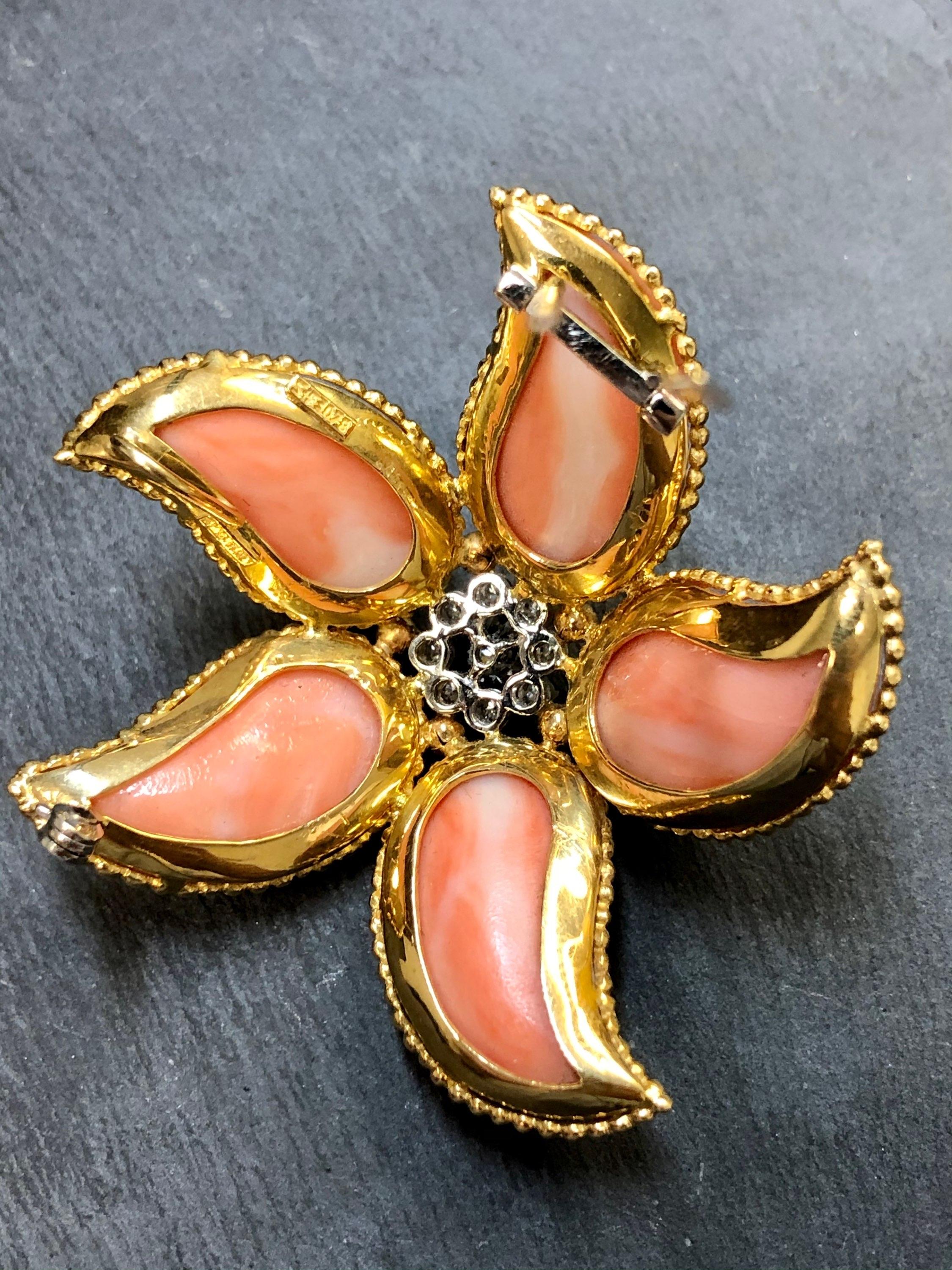 A large brooch done in 18K yellow gold and platinum circa 1960’s done in polished coral and approximately .60cttw in diamonds. By Spitzer & Furman.

Dimensions /Weight
Just over 2 1/4” in diameter. Weighs 23.8dwt.

Condition
No damage to coral and