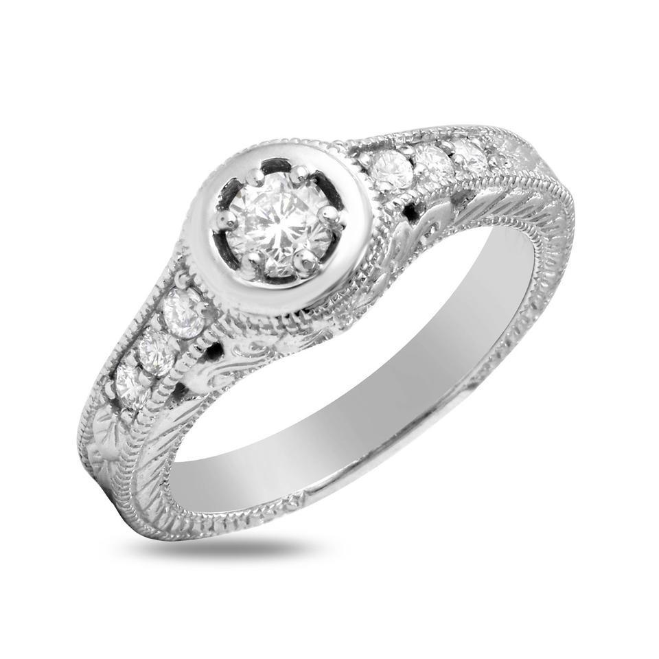 Splendid .65 Carats Natural Diamond 14K Solid White Gold Ring

Stamped: 14K

Total Natural Round Diamonds Weight: .65 Carats (color F-G / Clarity VS2-SI1)

Side Diamonds are: .30ct (VS2-SI1 / G)

Center Diamond is .35ct (SI1 / H)

The width of the