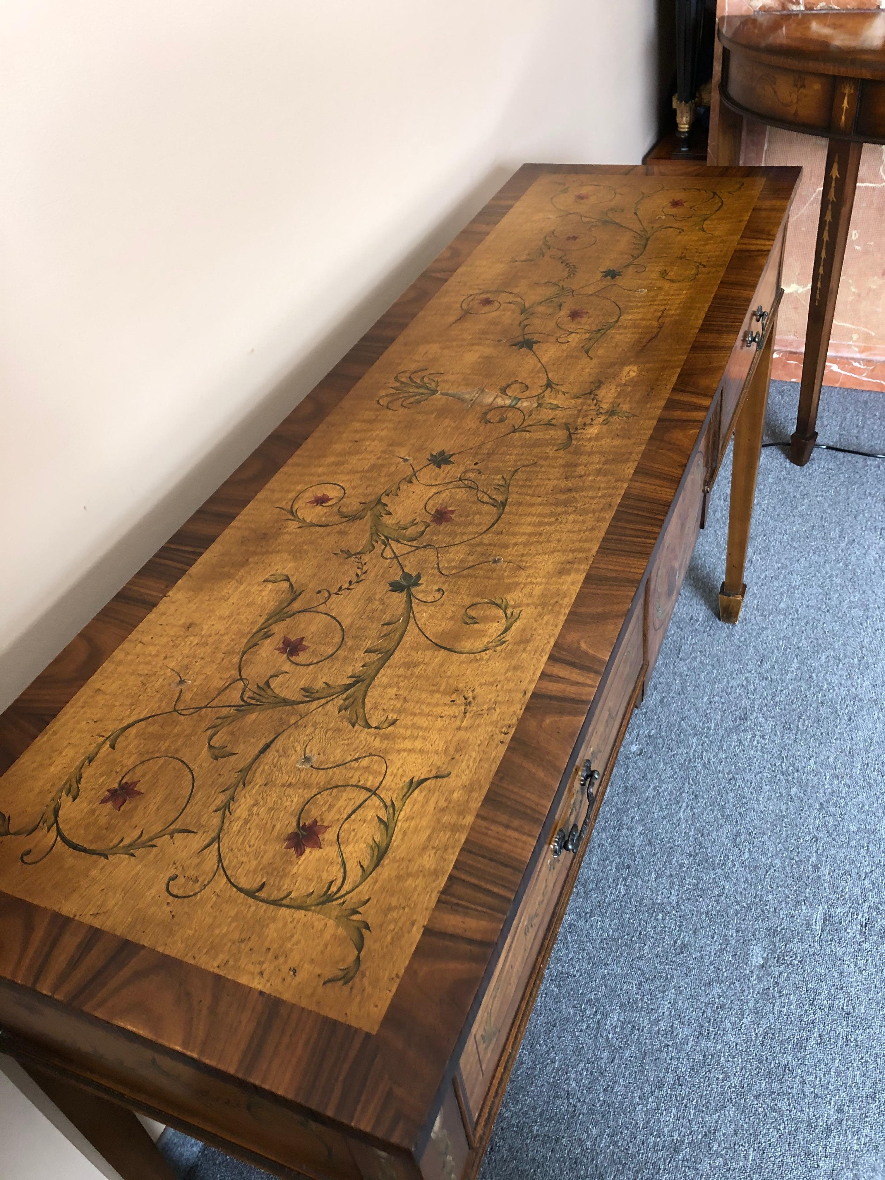A lovely English banded walnut and mixed wood inlay Adam style rectangular console table having pretty hand painted embellishments.