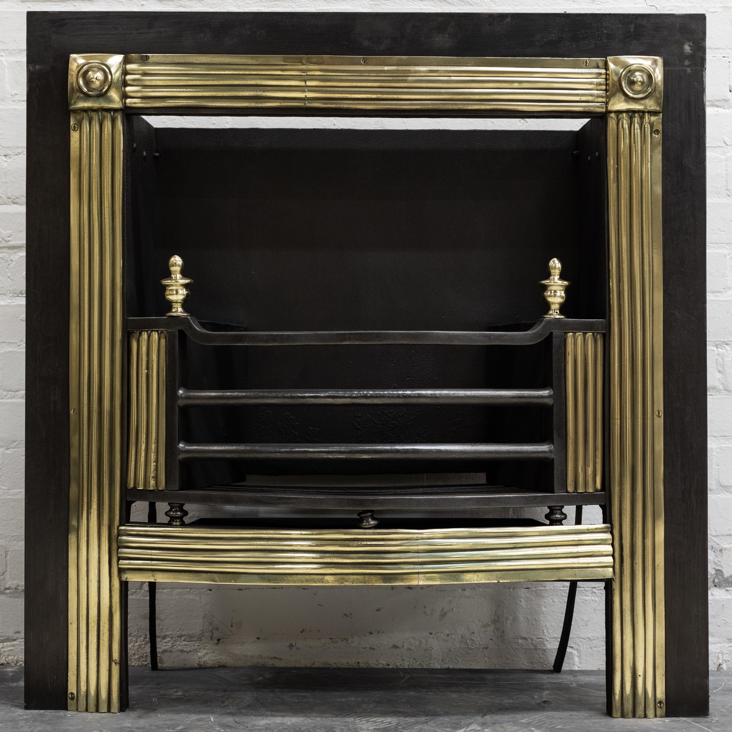 Un très grand et magnifique insert de grille de cuisson géorgien ancien.

Les élégantes colonnes en laiton cannelé encadrent l'ouverture et flanquent le panier.  Des fleurons en laiton en forme d'urne se trouvent au-dessus du panier substantiel. Des