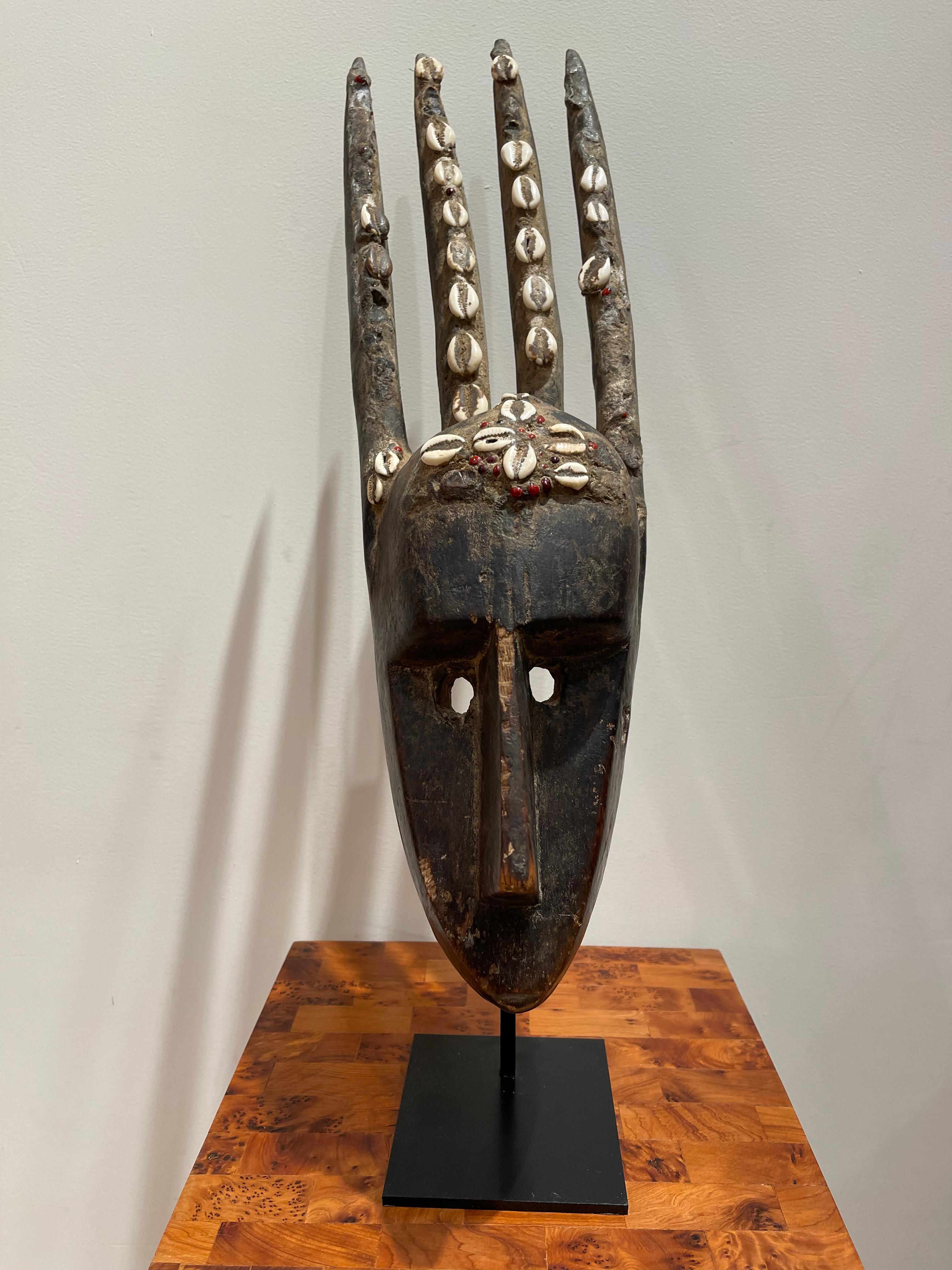 
Splendid four rams  Ntomo Mask, Bamana Population, Mali
Four Rams, Ntomo Mask, Mali, Wood and cowrie shells. Dimensions: 52 x 14.5 cm 20.48 x 5.51inches
The Ntomo mask is used in the initiation rituals of young men in populations across Western