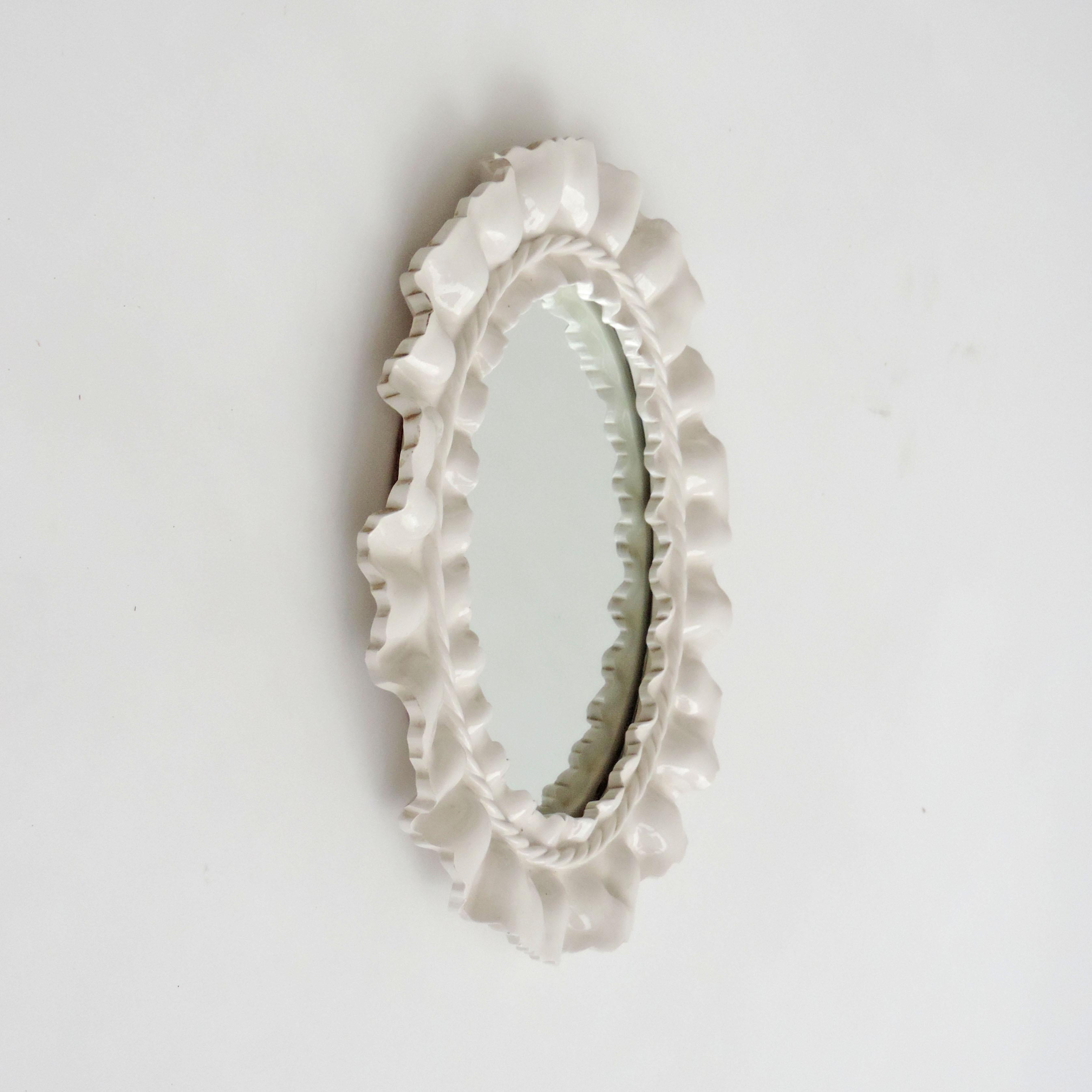 Splendid Italian 1950s surreal ceramic wall mirror.
In white, very decorative.