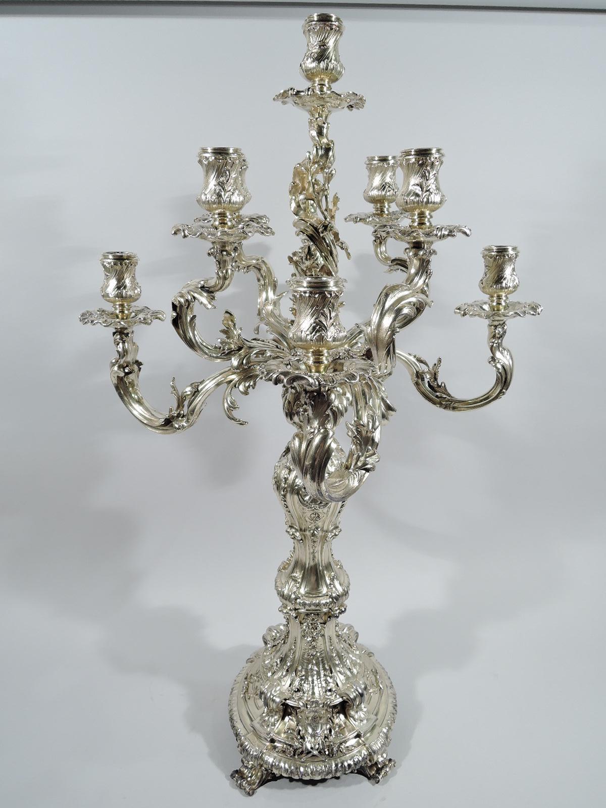 Pair of splendid and massive French Rococo 950 silver 9-light candelabra, circa 1880. Each: Baluster shaft on raised base with leaf-capped brackets and 4 scrolled feet. Low-relief shell, leaf, and scroll ornament. Central socket on open and twisting