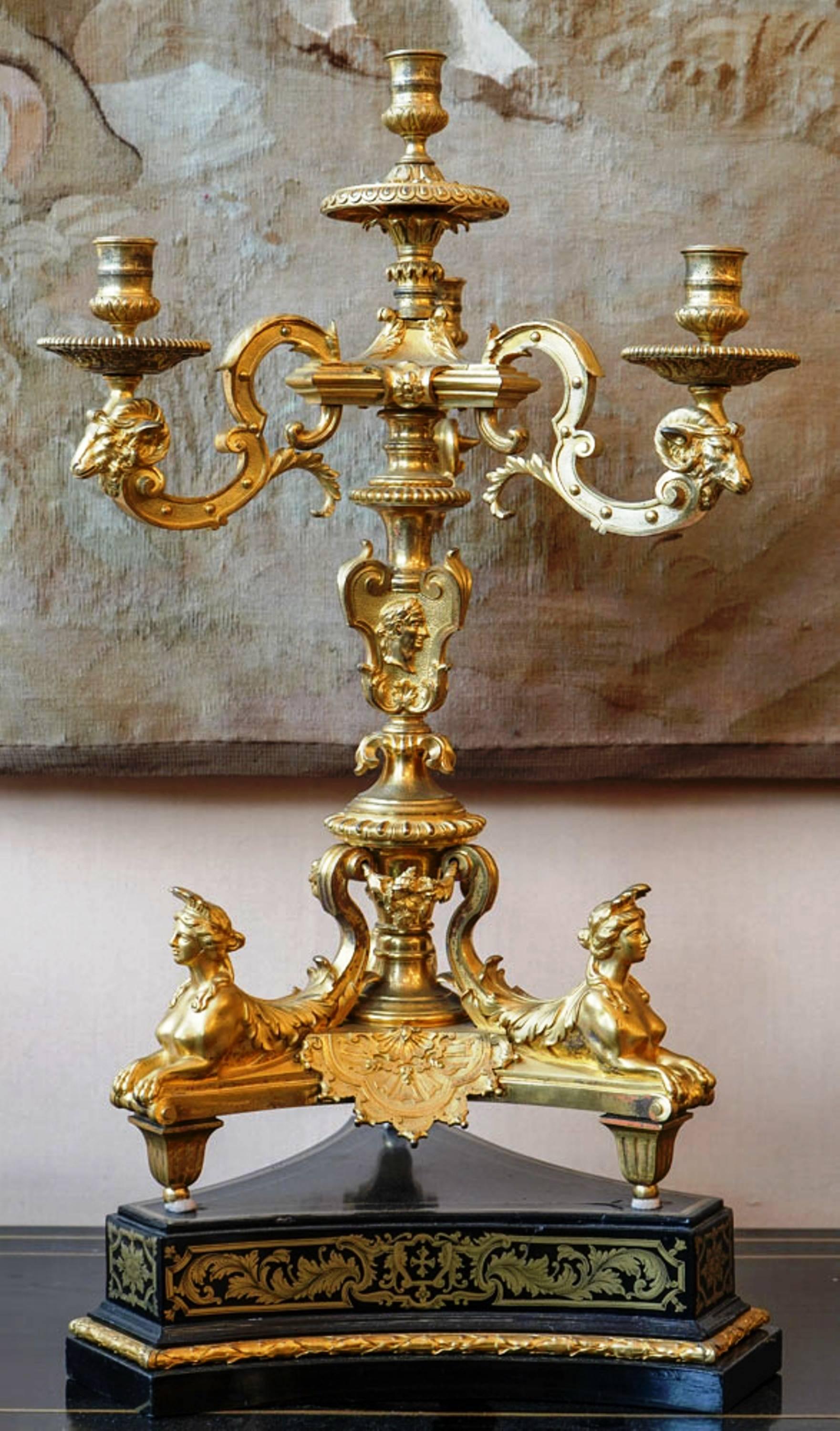 Splendid pair of candelabras, gilt bronze, Louis XIV style, France, circa 1880.
After a model by André Charles Boulle.
The base carved in ebony with copper ingravings, ty pical of the Boulle workshop.
They are decorated with sphinxes and heads of