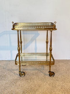 Brass bar cart a, "Hollywood Regency" style with glass tops, 1970s