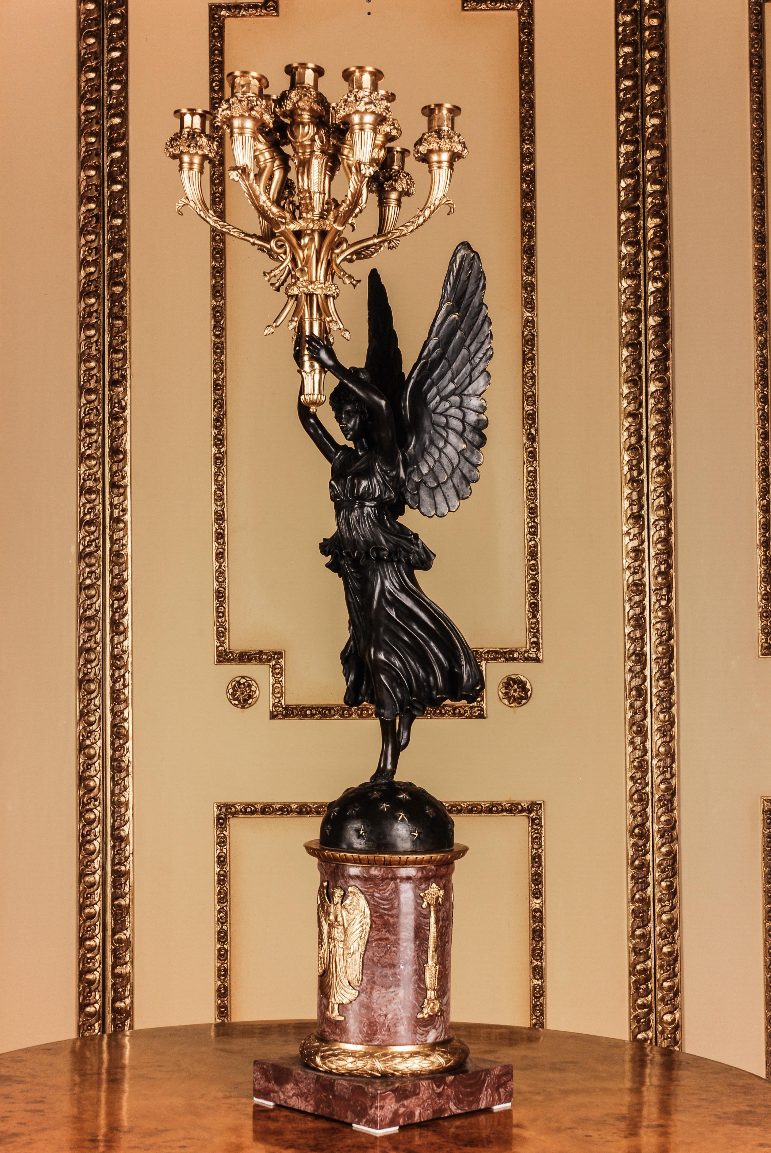 Exceptionally fine engraved and moulded bronze. Fully moulded
Designed figurines (Victoria). Overhead and hand held torch formed
shaft with 12 fully Horn-style sweeping light arms. This model belongs
to the exceptionally proportioned candelabras,