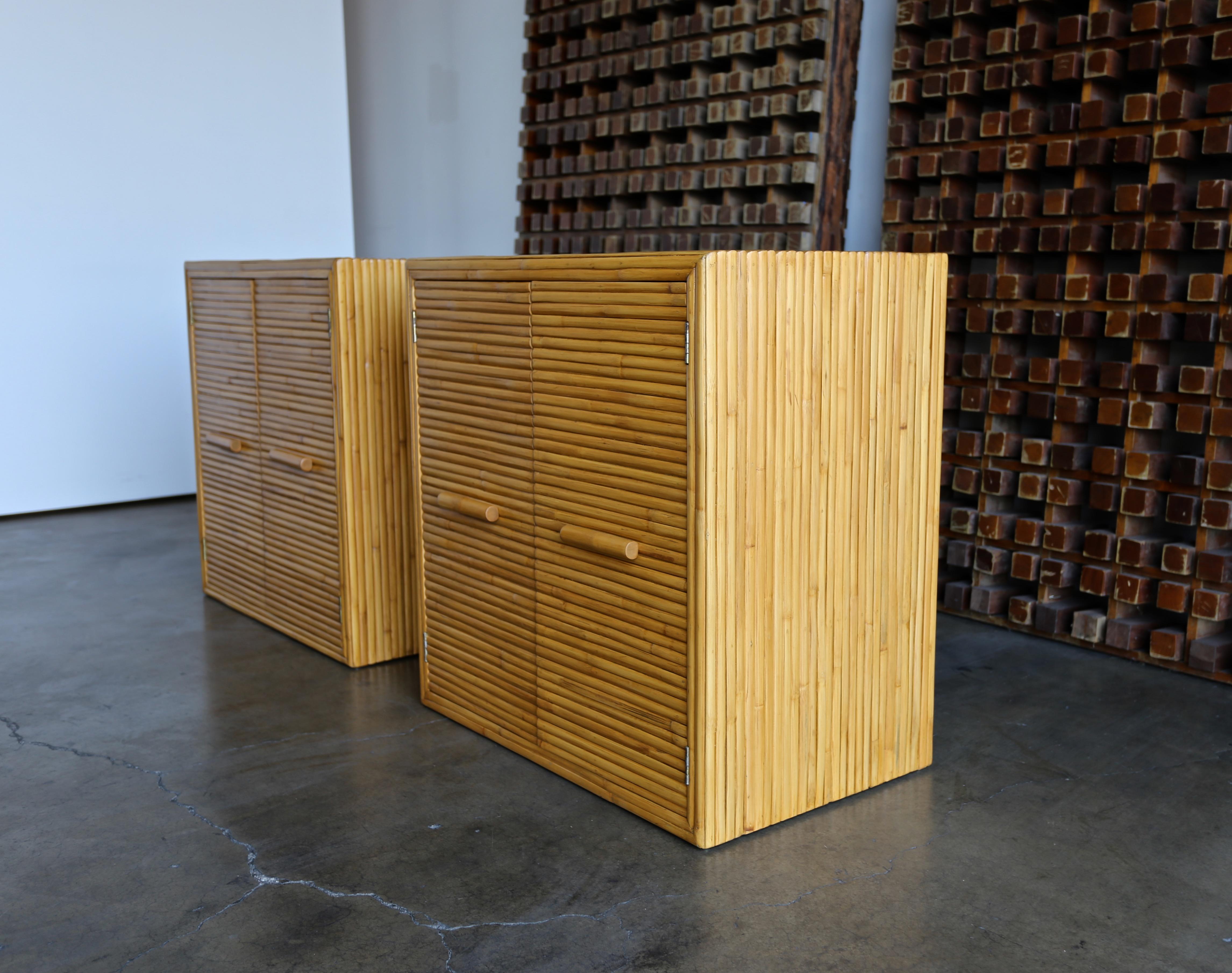 Pair of split bamboo cabinets, circa 1970. These cabinets future a finished back. This pair has been professionally restored.