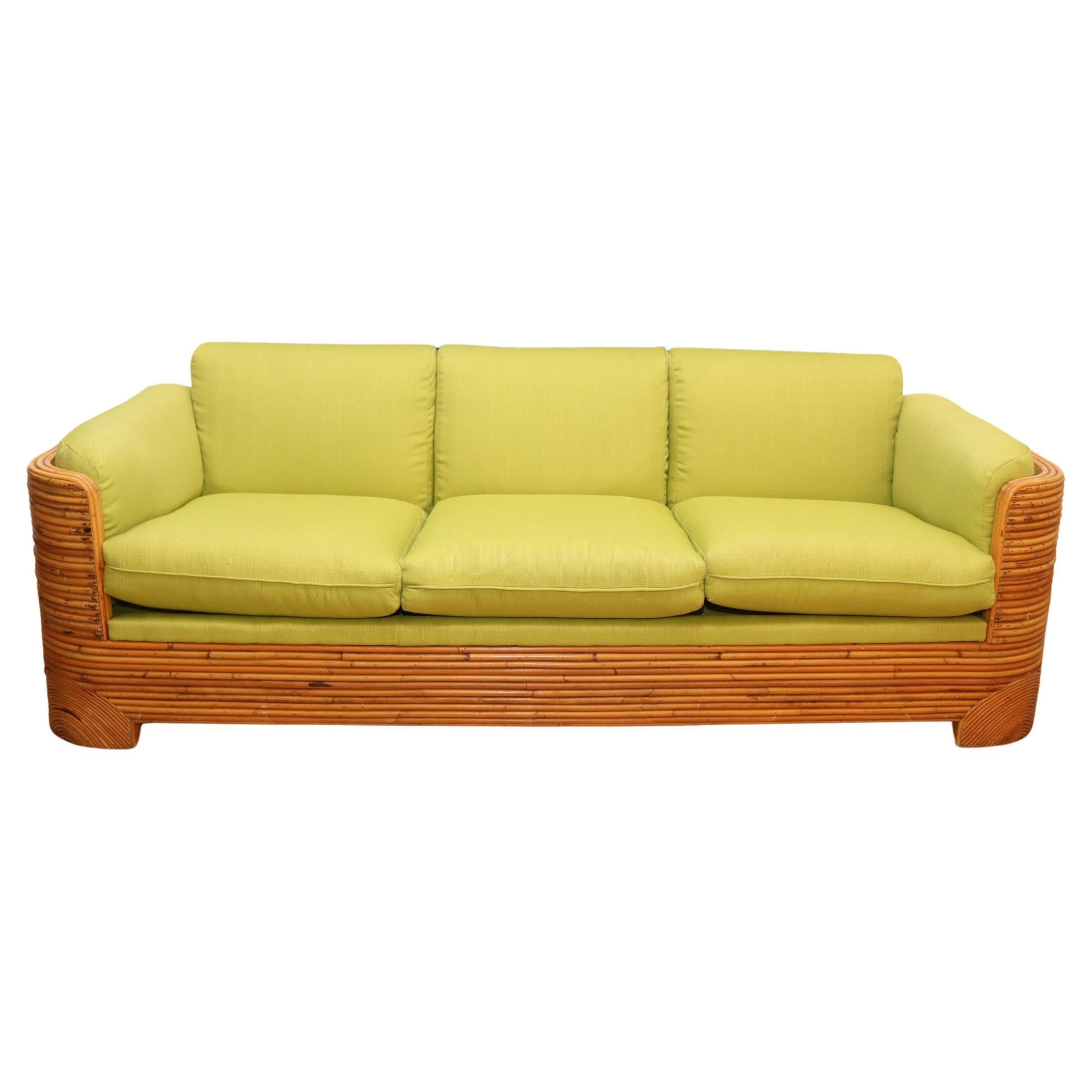 Split bamboo sofa, 
Circa 1970 USA
Generous proportion and curved lines
Newly upholstered in chartreuse fabric
Bamboo retains a warm original patina
