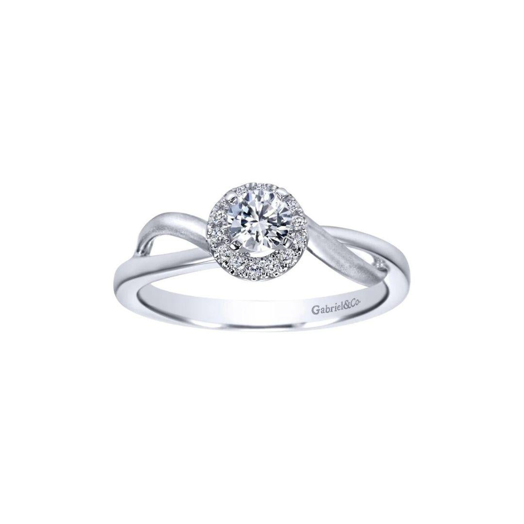 Diamond Halo Engagement Ring in 14k White Gold.﻿ Ring features a sophisticated satin design on a bypass split shank and a beautiful diamond halo, surrounding the center diamond. Total diamond weight, including the center diamond, is 0.36 ctw, H