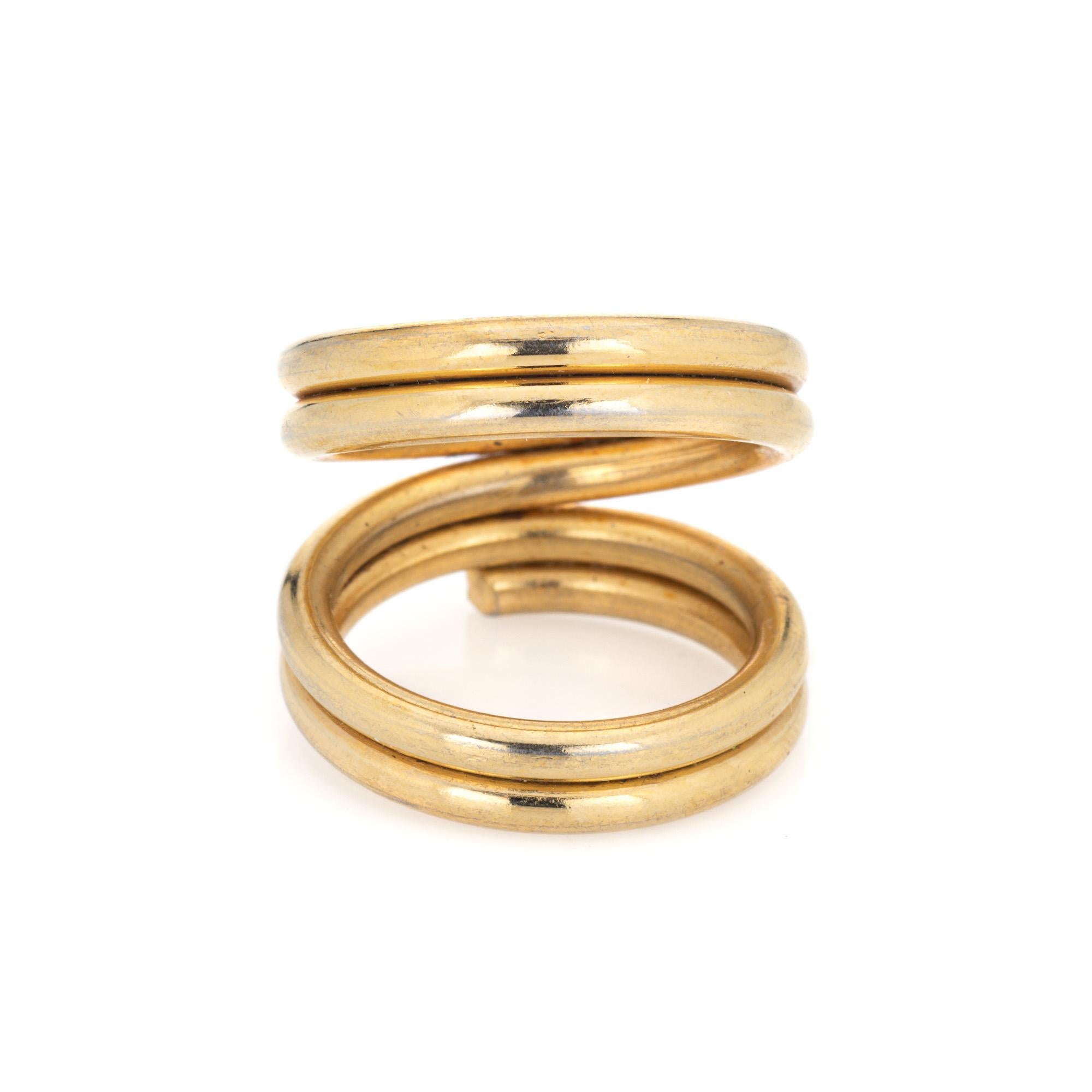 Finely detailed split coil ring crafted in 18 karat yellow gold. 

With a split design the striking ring is great worn alone as a statement piece or stacked for maximum effect. The low rise ring (4mm - 0.15 inches) sits comfortably on the