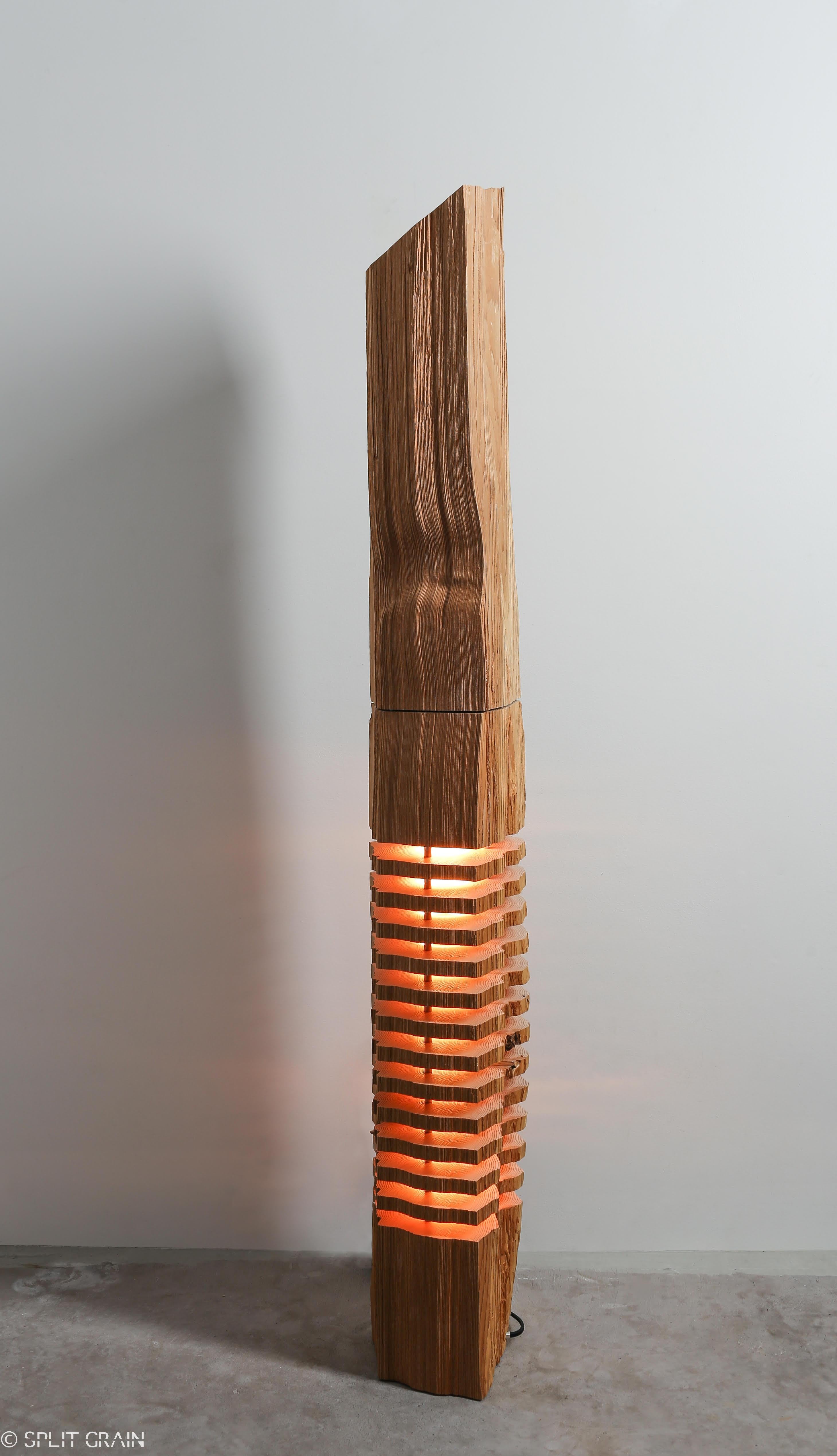 Large split grain cedar wood illuminated sculpture. Handcrafted by 20th century artist Paul Foeckler, this one of a kind illuminated sculpture reveals the elemental form and grain in a piece of reclaimed California Incense Cedar. Fascinating details