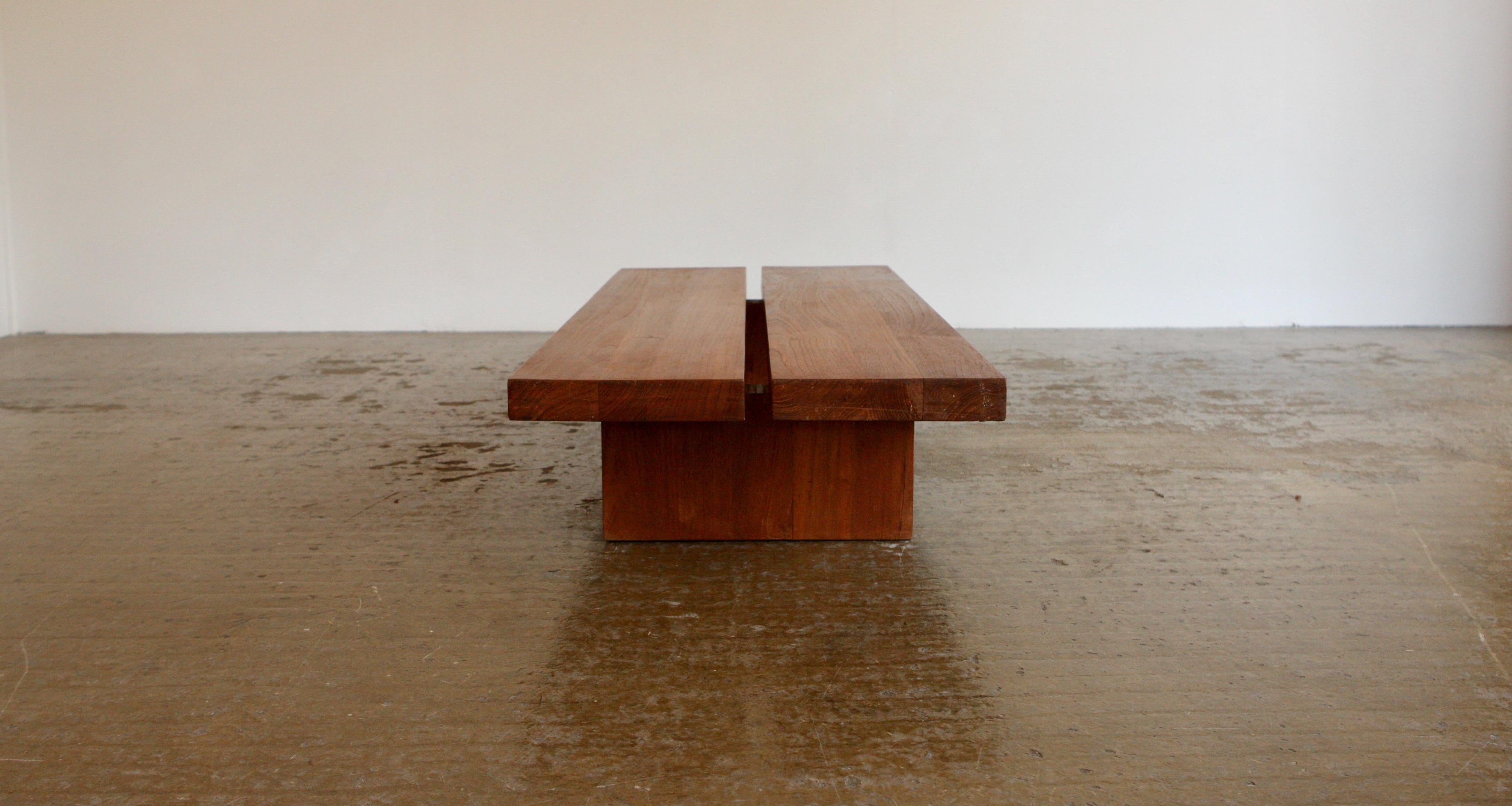 This is a French 1960's coffee table consisting of two thick split slabs of wood on two dove tailed feet. A minimalist design, with great proportions and good quality craftsmanship.
