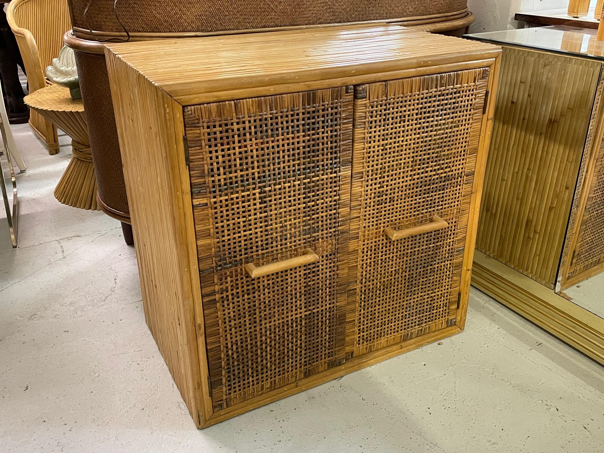 Double door cabinet features full veneer of split reed rattan and woven wicker door fronts. Very good condition with minor imperfections consistent with age.