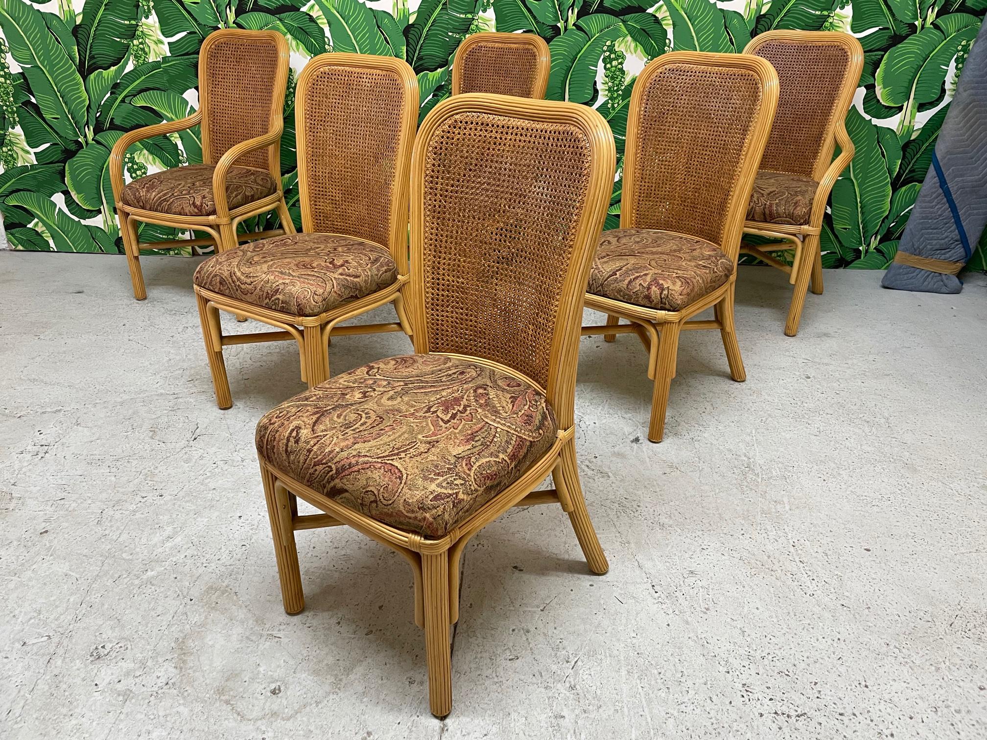 Set of six rattan dining chairs feature full veneer of pencil reed and double caned backs. Very good condition with minor imperfections consistent with age.

Background courtesy of Dorothy Draper 