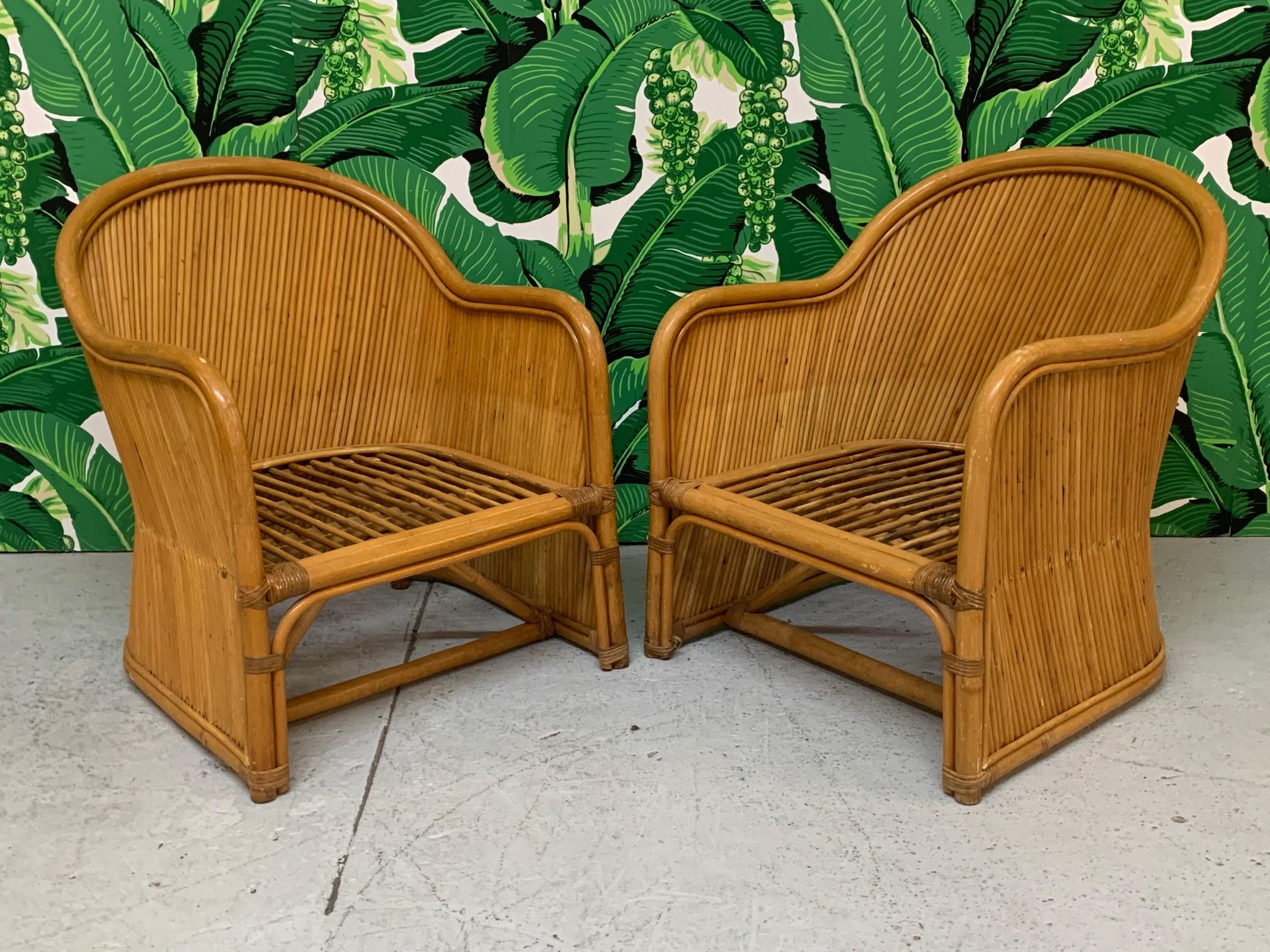 Pair of barrel style club chairs wrapped in split reed rattan. Good vintage condition with minor imperfections consistent with age.