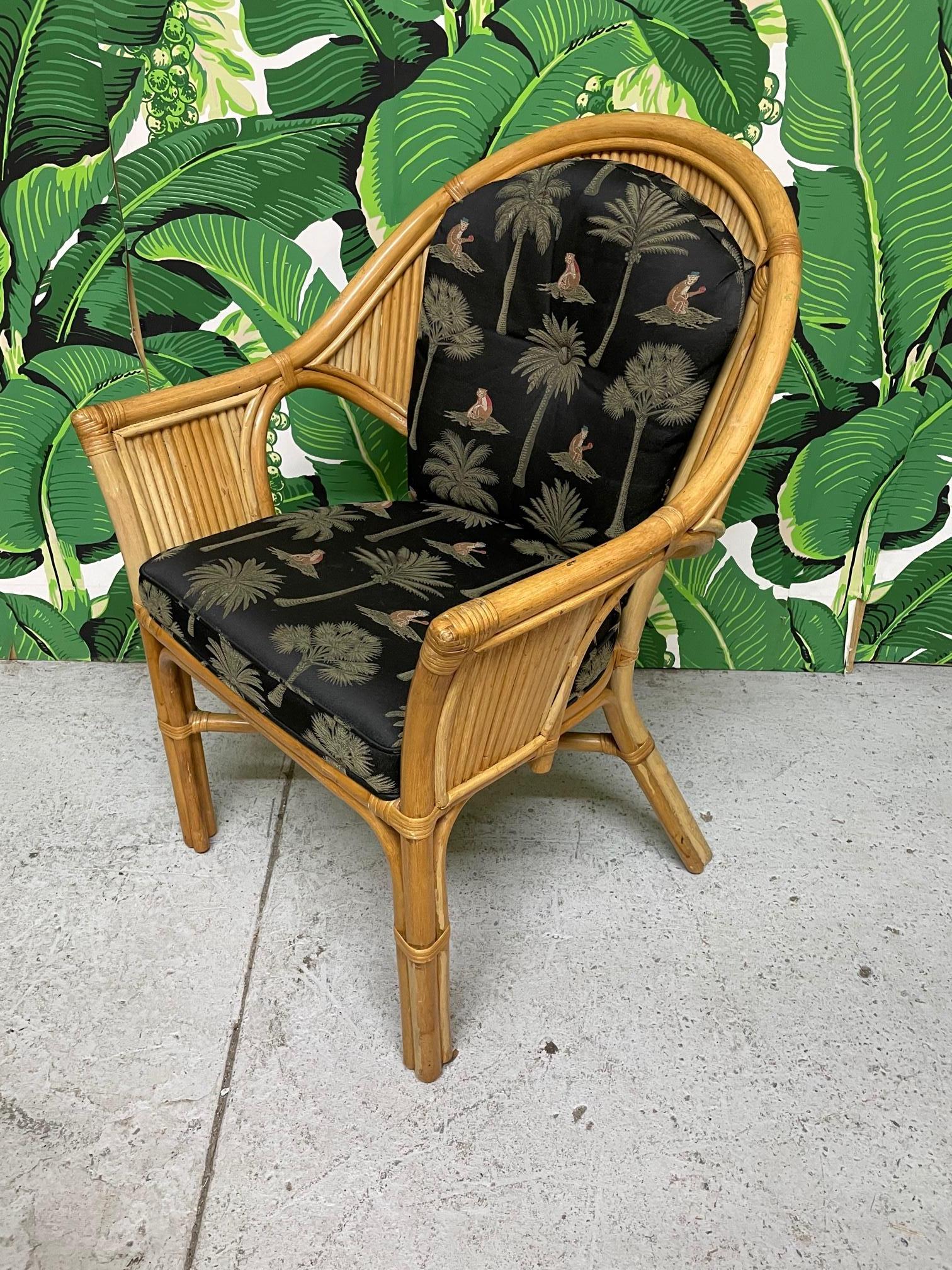 Set of six vintage rattan dining or club chairs veneered in pencil reed rattan and upholstered in a tropical palm print. Very good condition with minor imperfections consistent with age.
