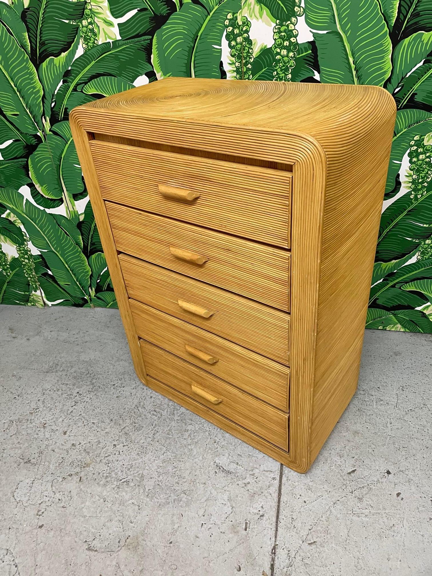 Rattan dresser features a full veneer of pencil reed rattan in a rising sun pattern echoing the designs by Gabriella Crespi. Good condition with minor imperfections consistent with age.

 
