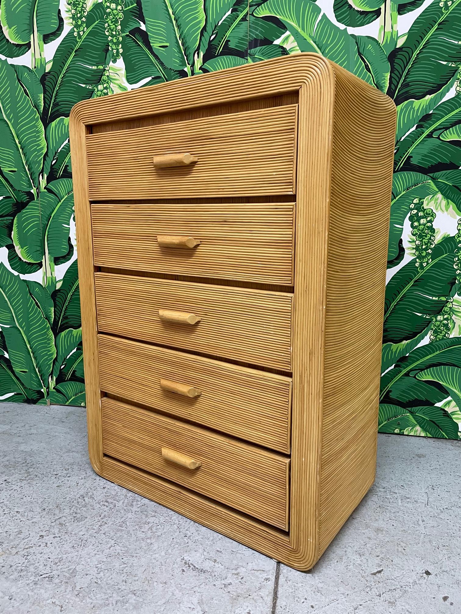 Rattan dresser features a full veneer of pencil reed rattan in a rising sun pattern echoing the designs by Gabriella Crespi. Good condition with imperfections consistent with age, see photos for condition details. 

 