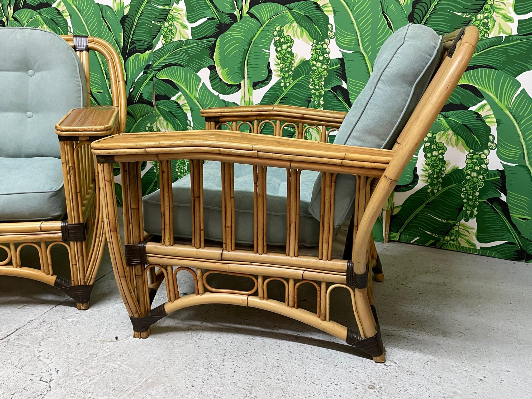 Pair of large rattan club chairs feature two tone design and split reed veneered arms. Extremely comfortable. Good condition with only minor imperfections consistent with age.