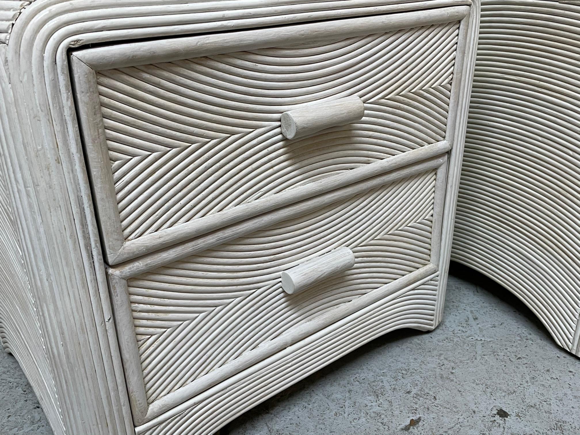 Pair of vintage nightstands feature a veneer of pencil reed rattan and a light egg shell color finish. Good condition with minor imperfections consistent with age.