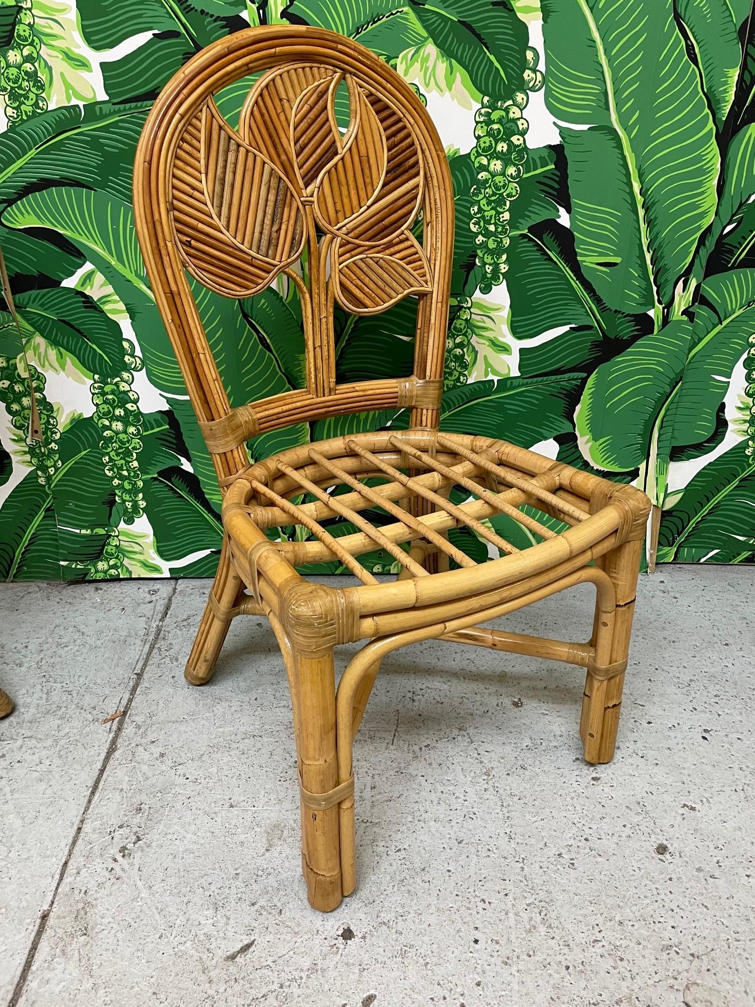 Set of six rattan dining chairs feature pencil reed detailing in a tropical palm motif.  Excellent condition with only very minor imperfections consistent with age.