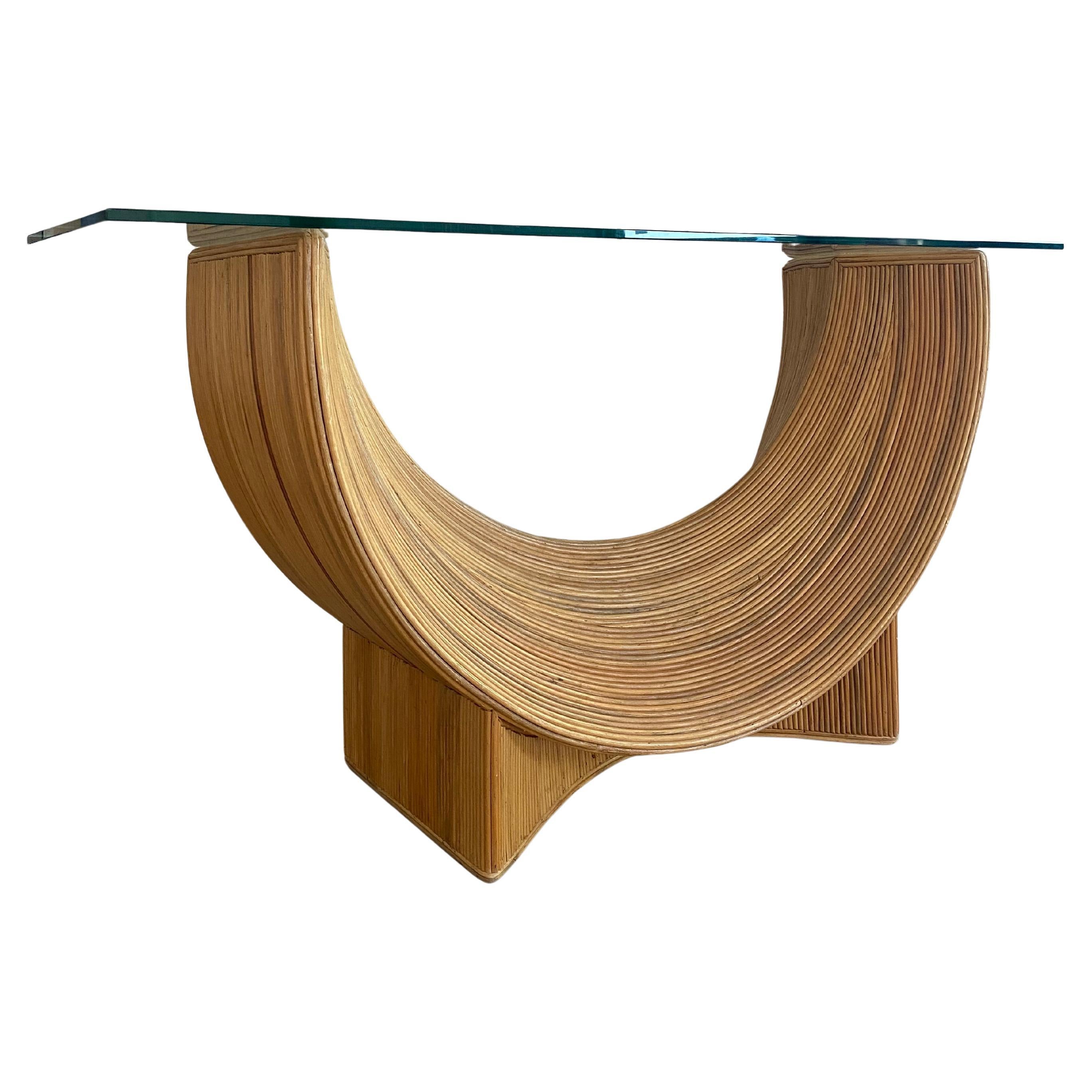 A stunning example of Organic Modern design, this sculptural console table is expertly hand-crafted with natural split reed meticulously applied over a sturdy wood frame, creating a beautiful sense of texture, warmth, and movement. The substantial