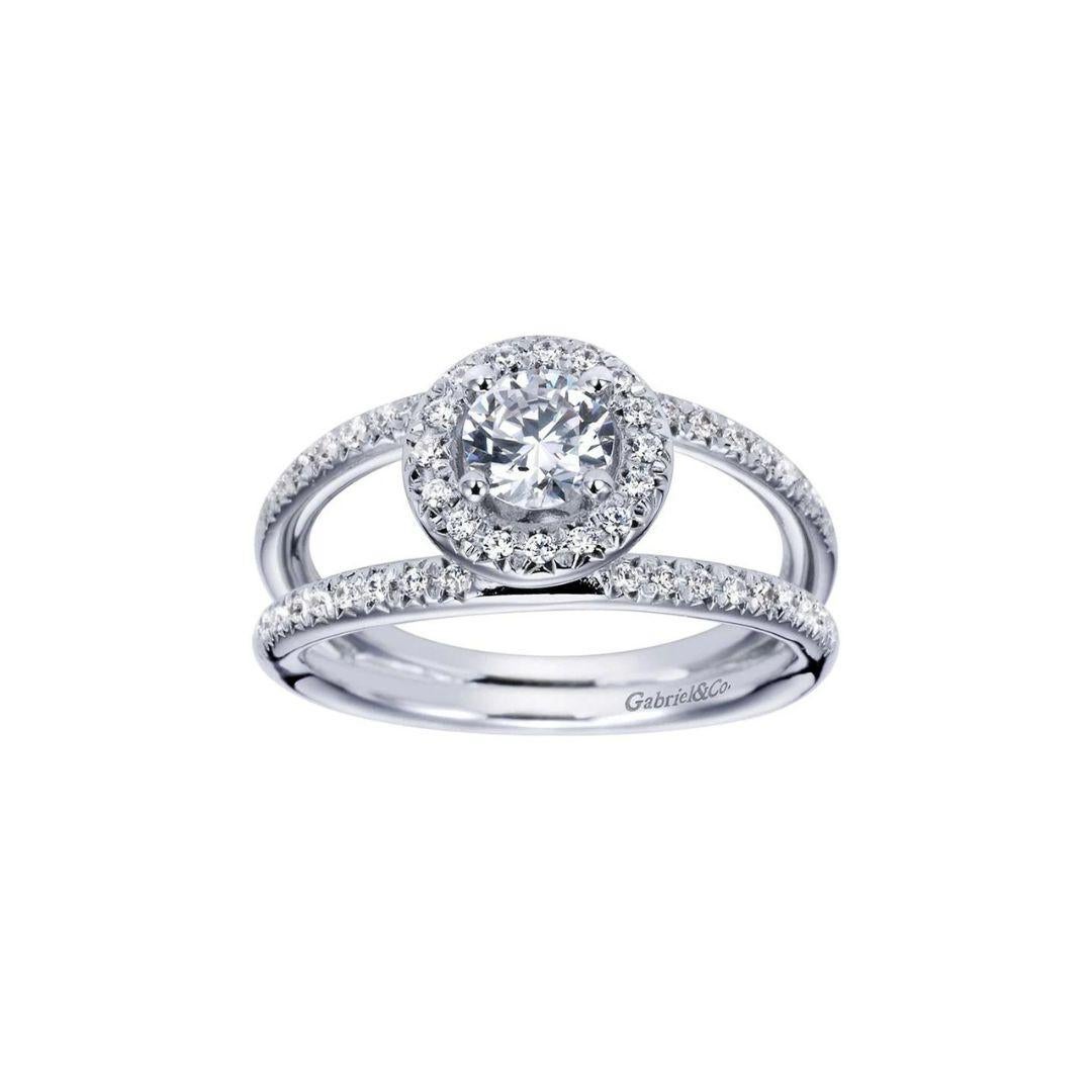 Split Shank Diamond Halo Engagement Ring in 14k White Gold.﻿ Center diamond weighs 0.50 ct, H color, SI1 clarity. Side diamonds are  0.25ctw, H color, SI1 clarity.