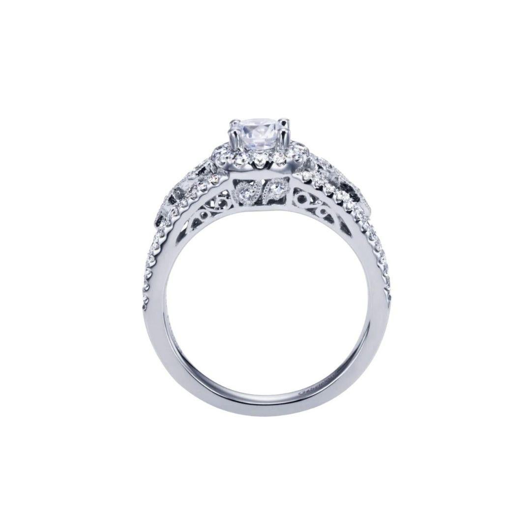 Ladies' 14k White Gold Diamond  Engagement Ring. Diamond pave on the ring's split shank extends to the sides of the center stone to give this one of a kind ring a romantic vintage appeal. Bezel set diamonds with a milgrain finish create a tasteful