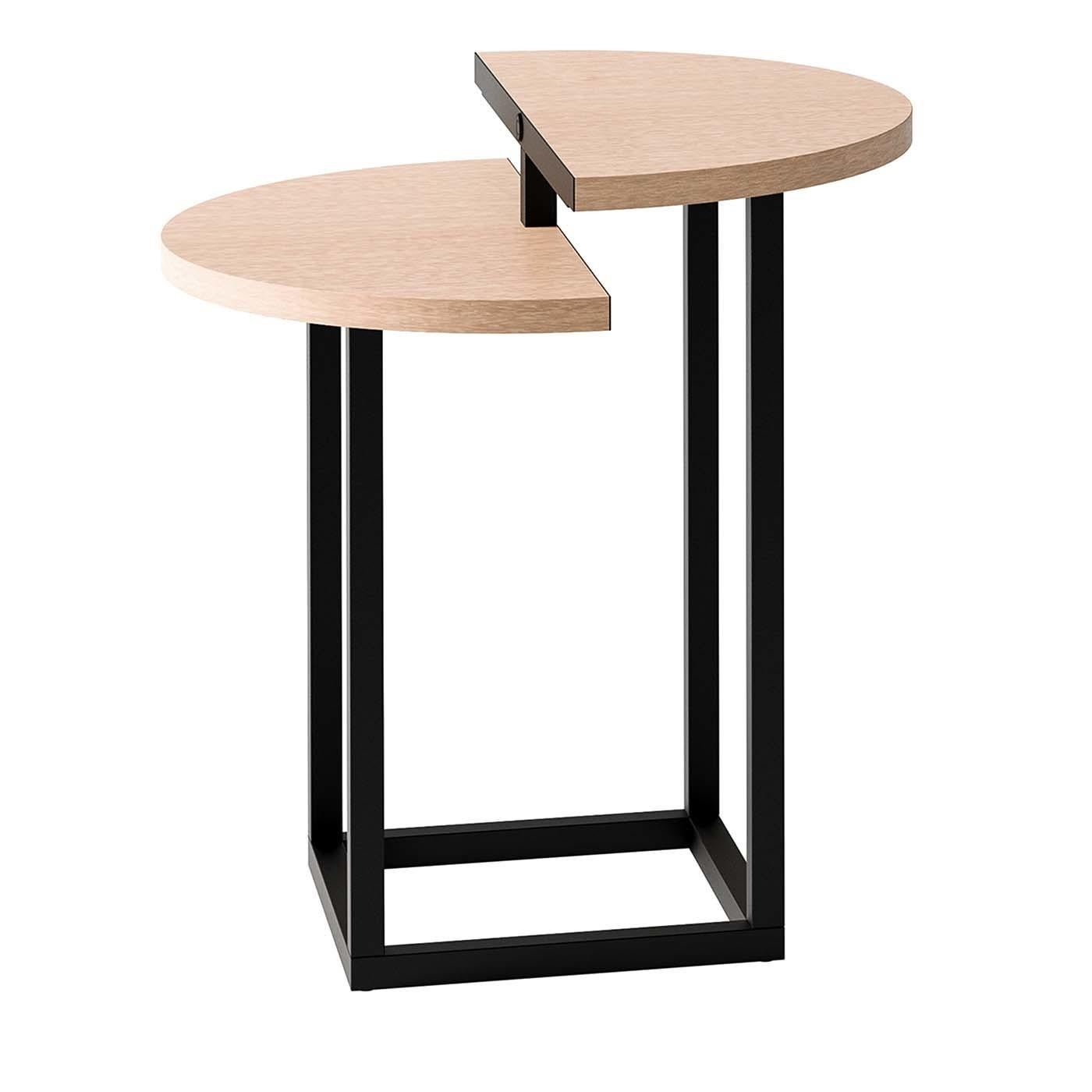 Combining refined minimalism with geometric intrigue, this side table is a versatile solution for small spaces. The split top is crafted of wood with beige eucalyptus veneer and is set at different heights atop a square metal base with a matte black