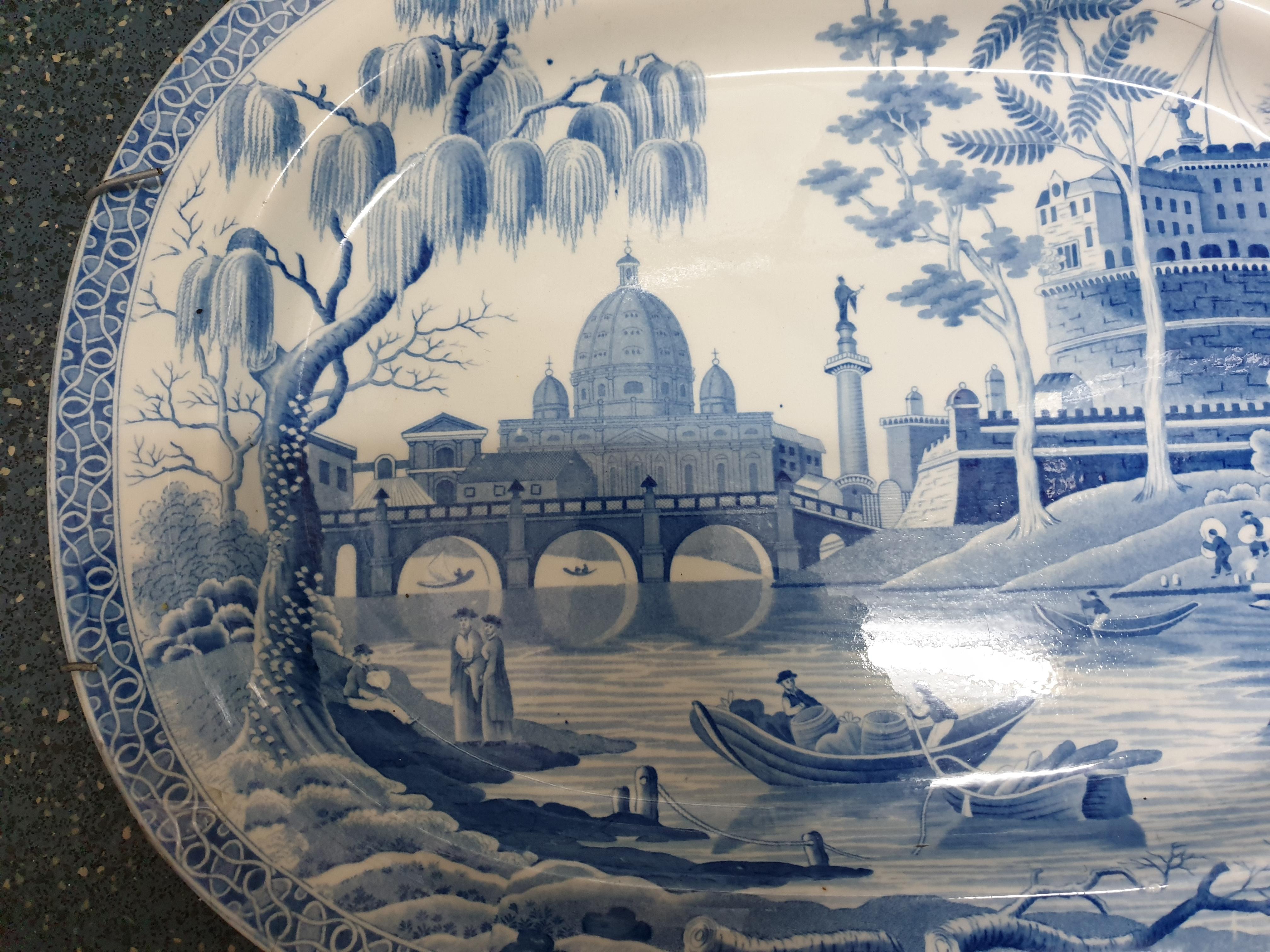 This fine English blue & white TRANSFER PRINTED serving Platter dates from circa 1820. It is decorated in their popular TOWER PATTERN, based on an engraving of the Bridge of Salaro and with a fanciful juxtaposition of St. Peter's monuments, Castle