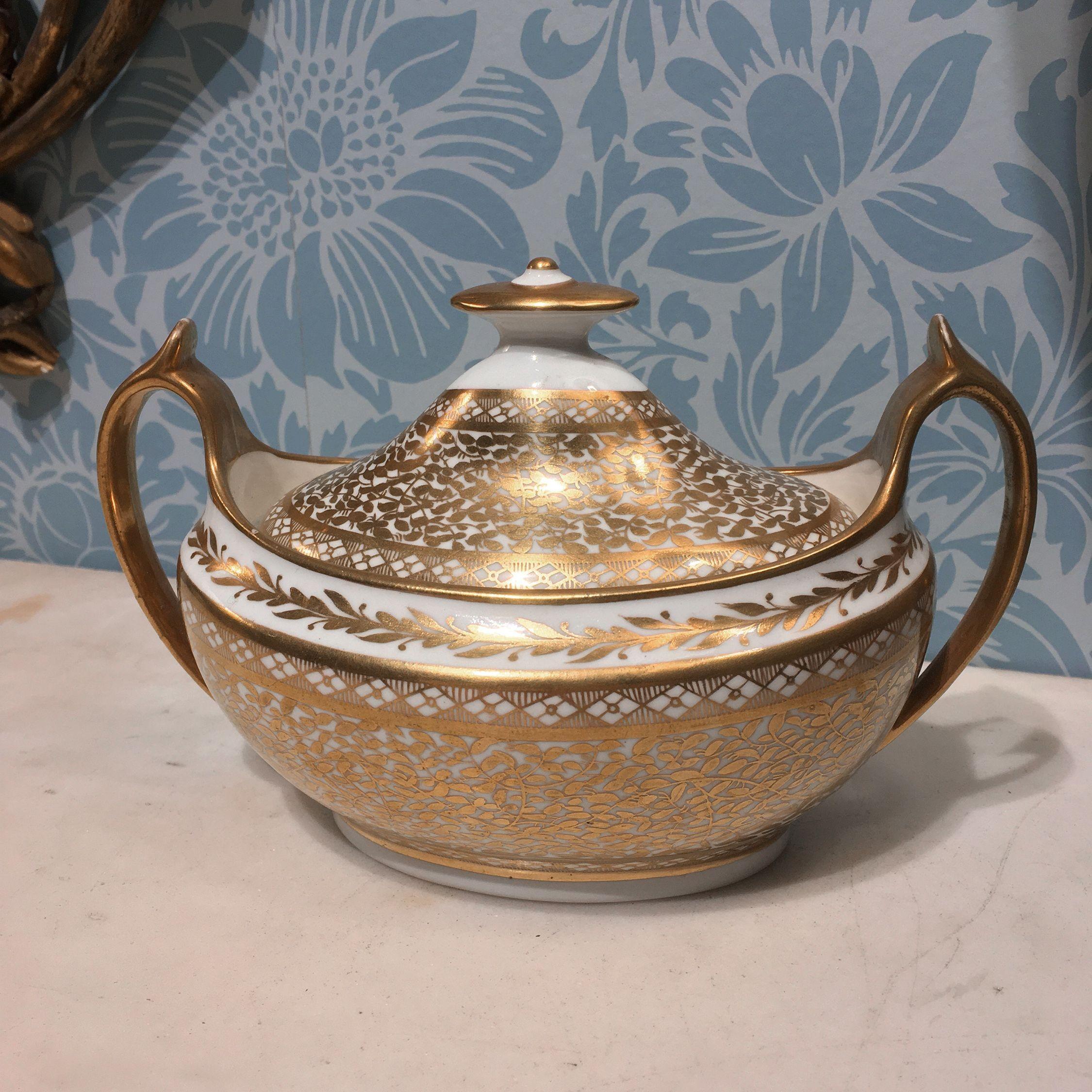 Spode double handled sugar bowl and cover. Oval-shaped porcelain body, gilt with diamond and vine motifs, the base impressed with an “S” and numbered “609”.