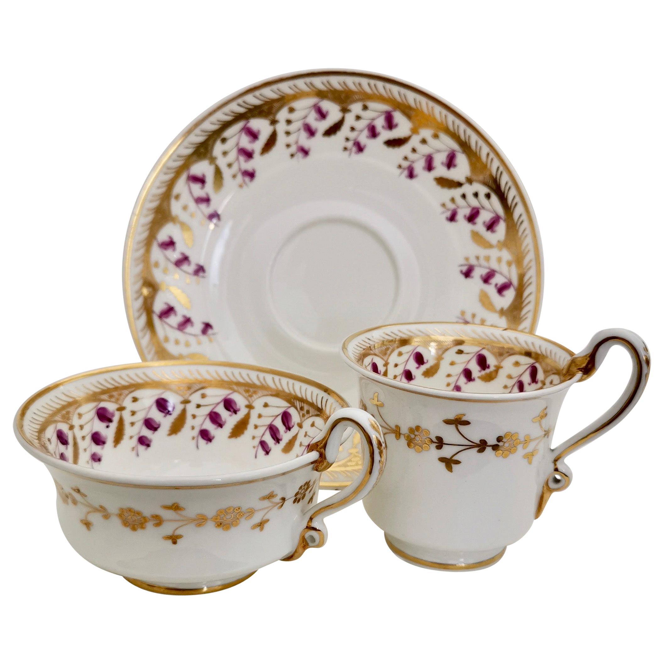 This is a beautiful true trio with serpent handles, made by Spode in about 1826, which was the Regency era. The trio is made in Felspar porcelain and decorated with the harebell pattern no. 3907, which dates to 1826. 

In the late 18th and early