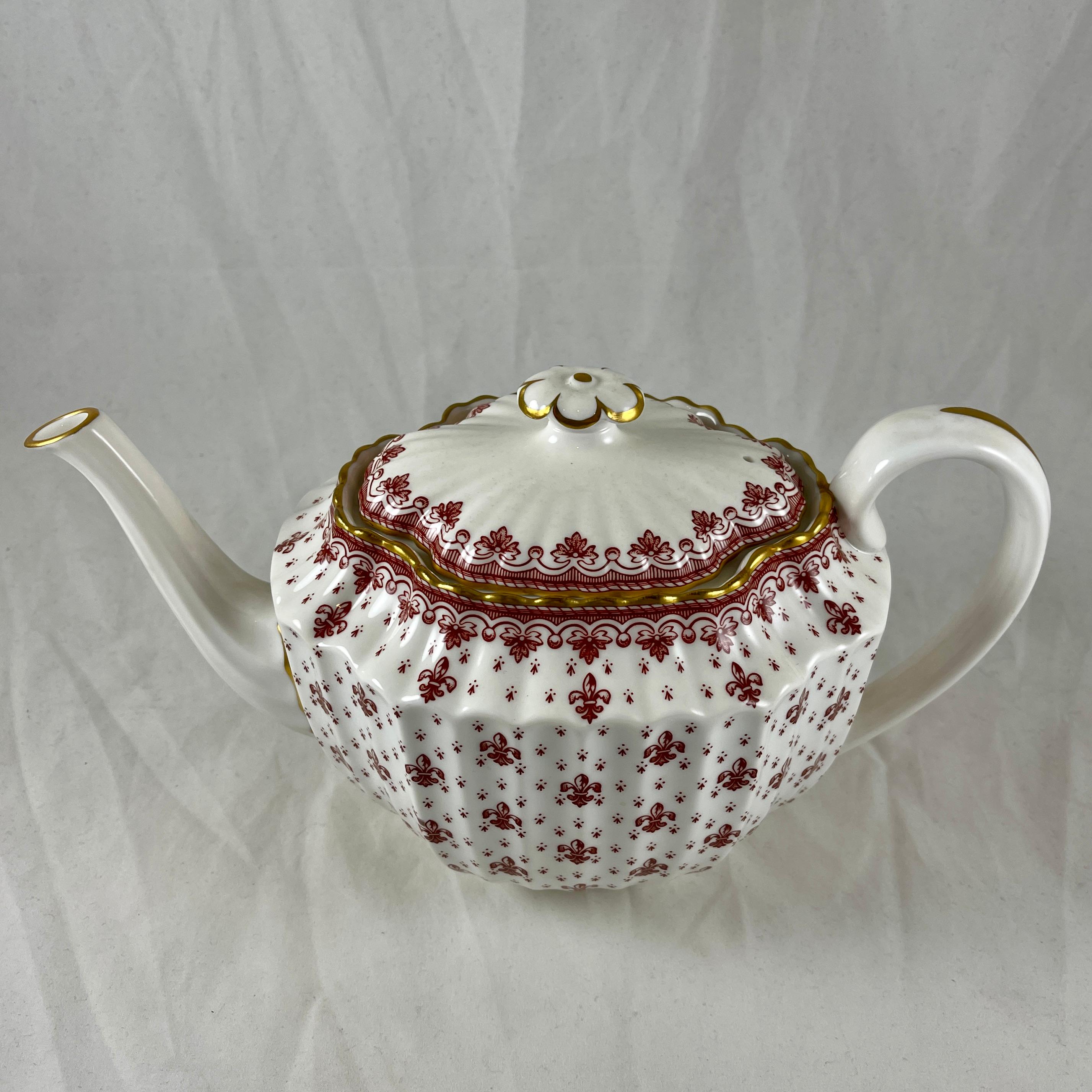 From Spode, England, a Fleur De Lys-Red Tea Pot in the fluted Chelsea shape.

The Fleur de Lys pattern was introduced in 1961 and remained active until 1994, now discontinued.

A bone china tea pot and lid, transfer printed in a bittersweet red
