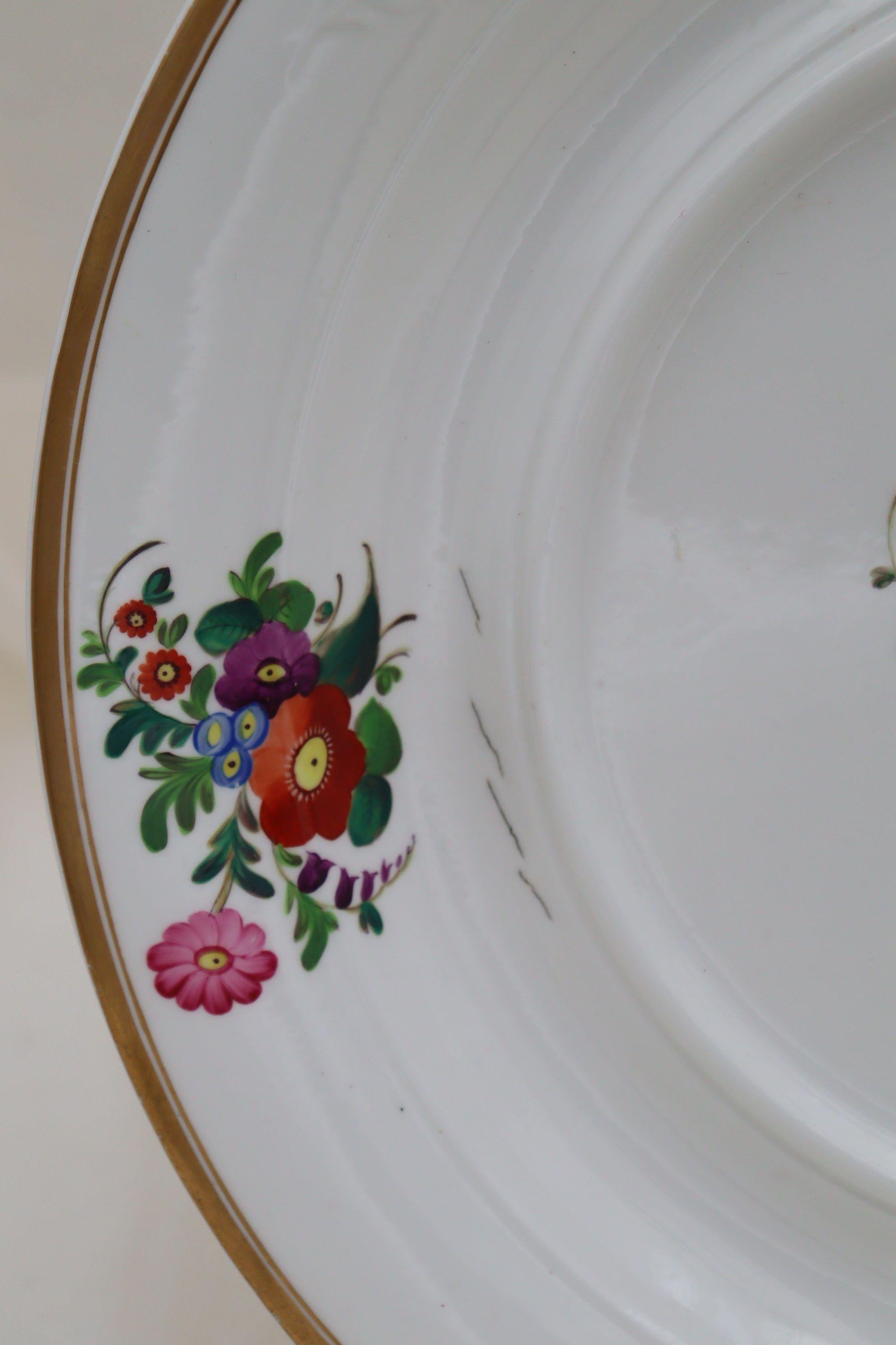 An attractive piece in its own right, this Spode hand painted and gilded porcelain stand would be the underdish for a large soup tureen. Around the rim are three moulded sprays of flowers left in the white, and between them are a further three hand