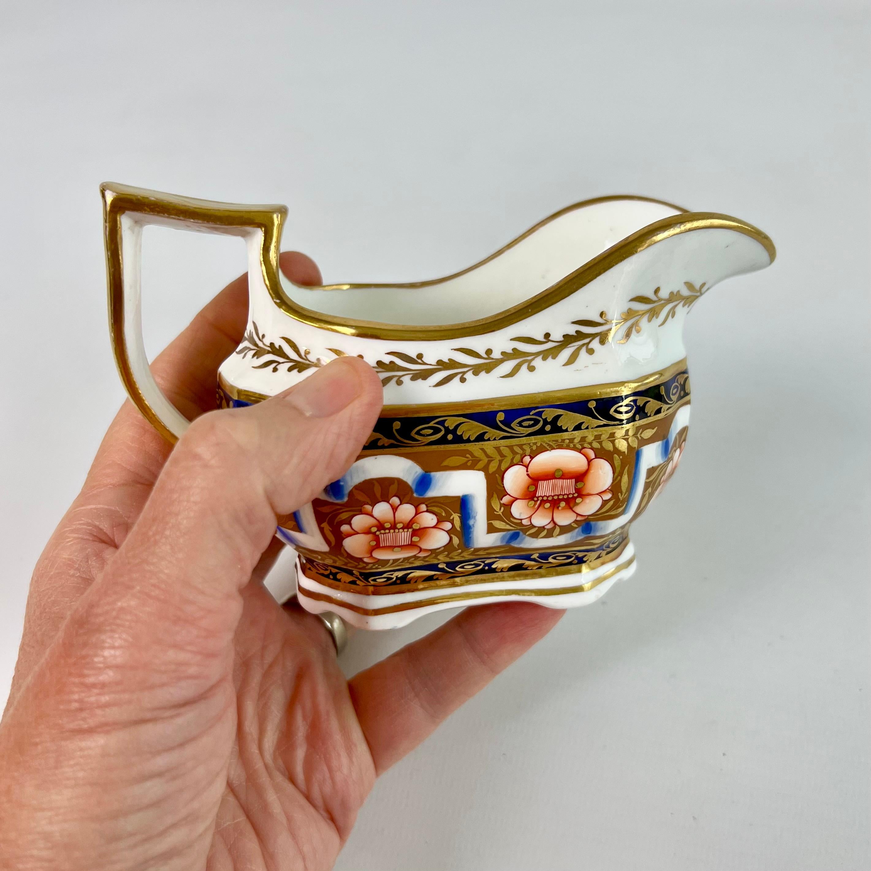 This is a beautiful milk jug or creamer made by Spode around 1825. The jug is decorated in a beautiful Neoclassical pattern in Imari colours and has a characteristic serpent handle. It has provenance: it came from the famous Solomon Andrews