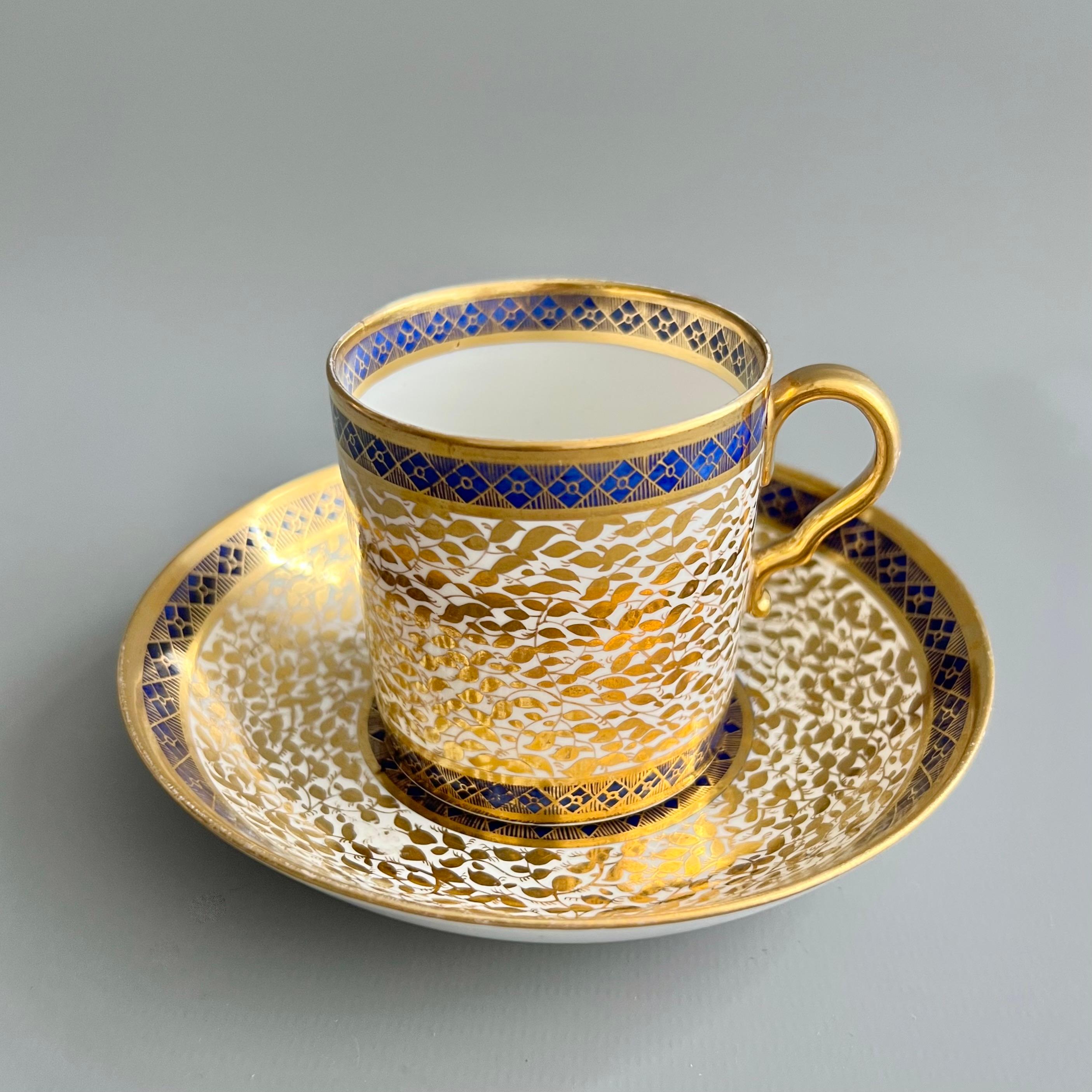 This is a beautiful coffee can and saucer made by Spode around 1806. The set is decorated in a stunning pattern of dense gilt foliage and a cobalt blue band in the Neoclassical taste.

Josiah Spode was the great pioneer among the Georgian potters in
